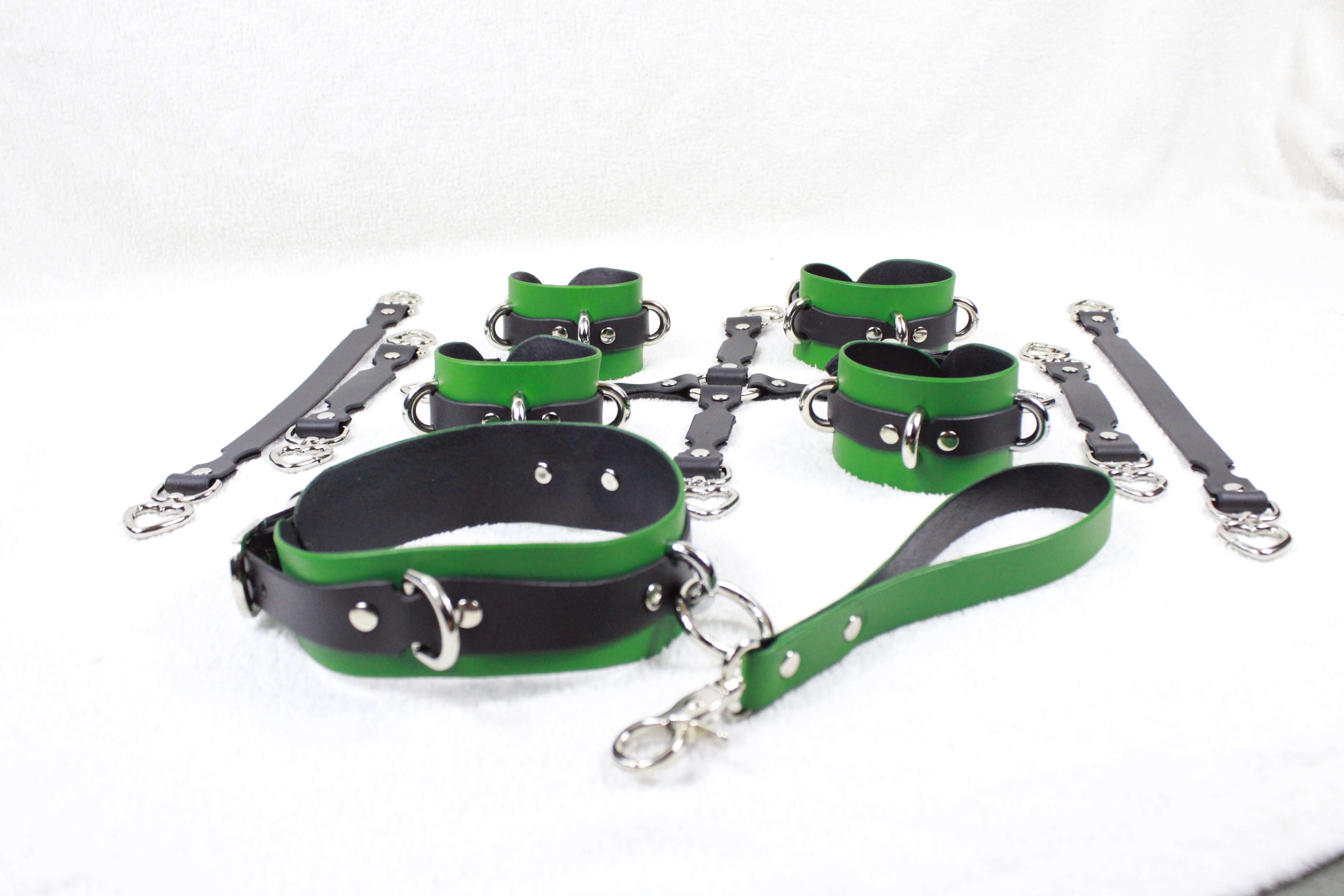 Safely using a bondage harness featuring black and green leather equipment on a white background.