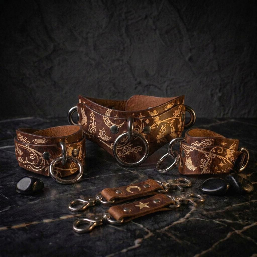a collection of leather straps and charms arranged on a dark surface, possibly a table or countertop.