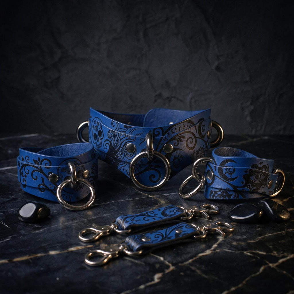 A collection of blue leather straps with metal rings and decorative patterns, arranged on a dark surface.