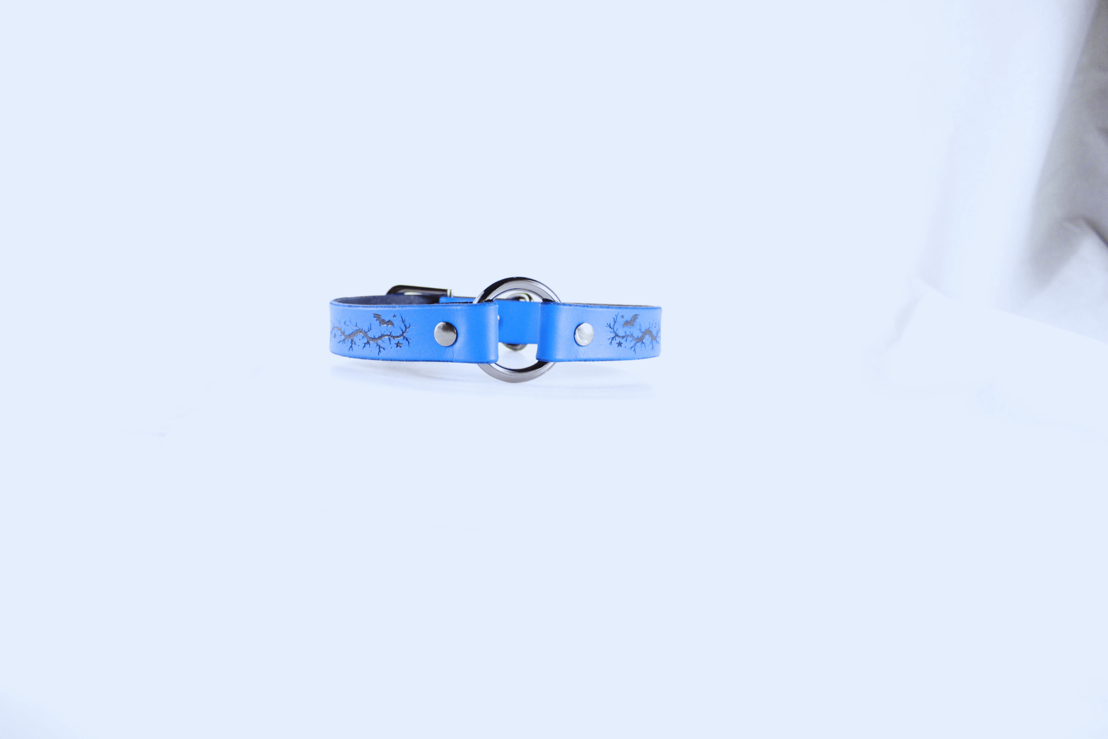Submissive Collar Blue Moon & Bats Leather Choker in blue, featuring crescent moons and bats design.