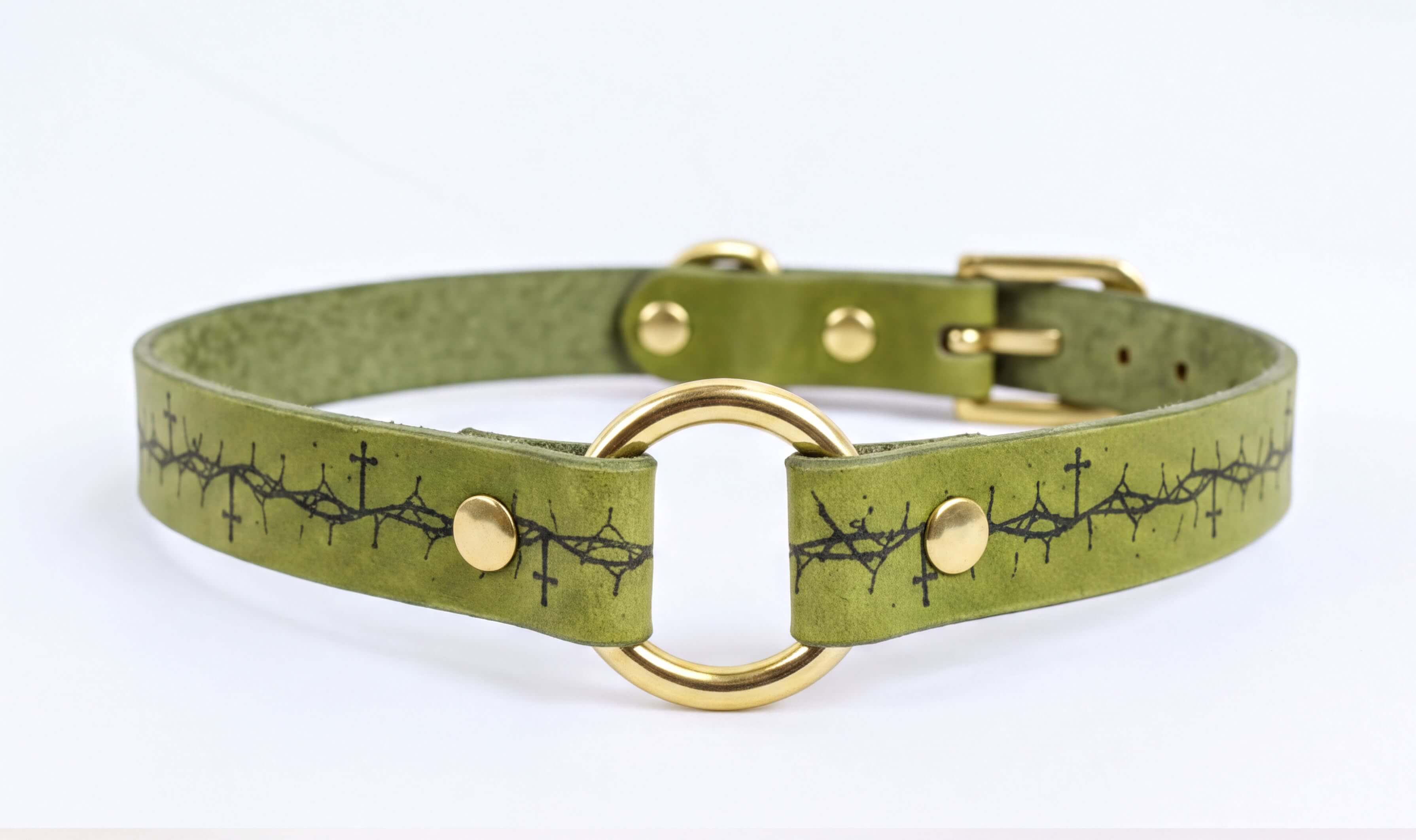 A green leather choker collar with a gold-colored buckle and a black design on the front.