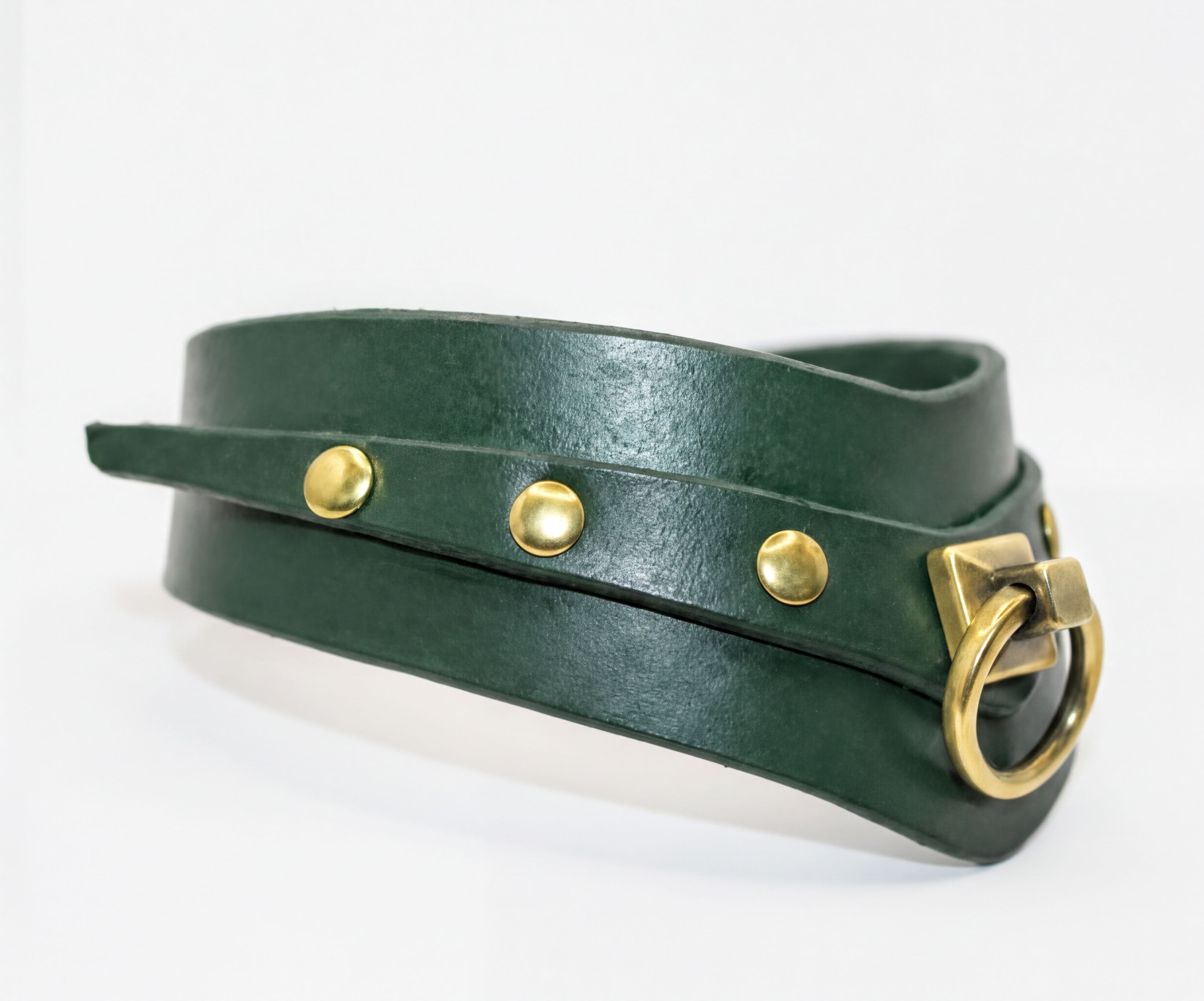 A green leather choker necklace with a brass buckle and three gold-colored studs.