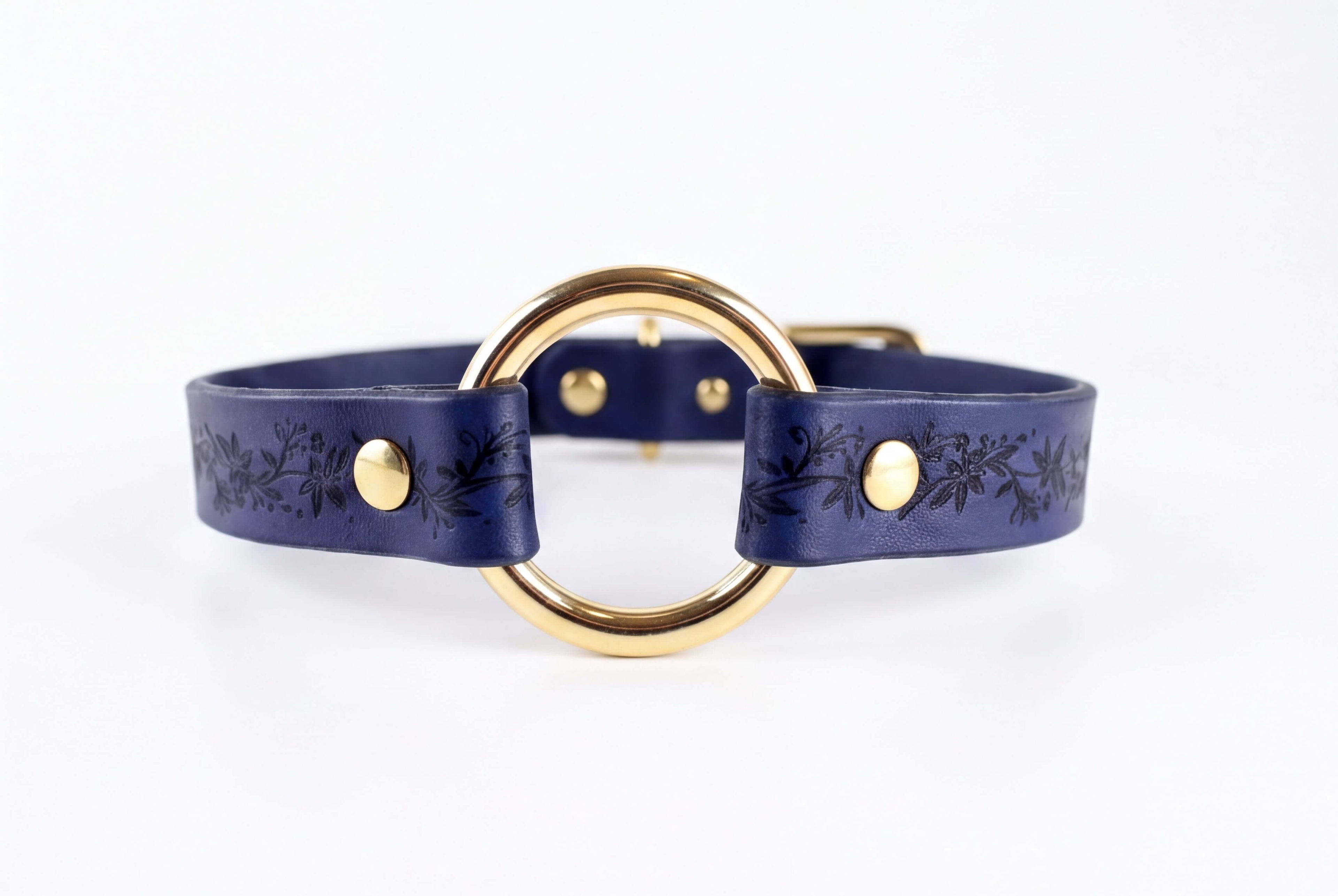 A blue leather choker necklace with a gold-colored circular buckle.