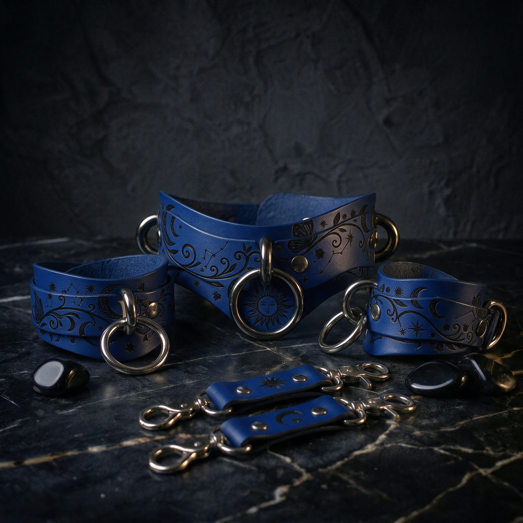 A collection of blue leather accessories, including choker necklaces and bracelets, with intricate designs and metal hardware, displayed on a dark surface.