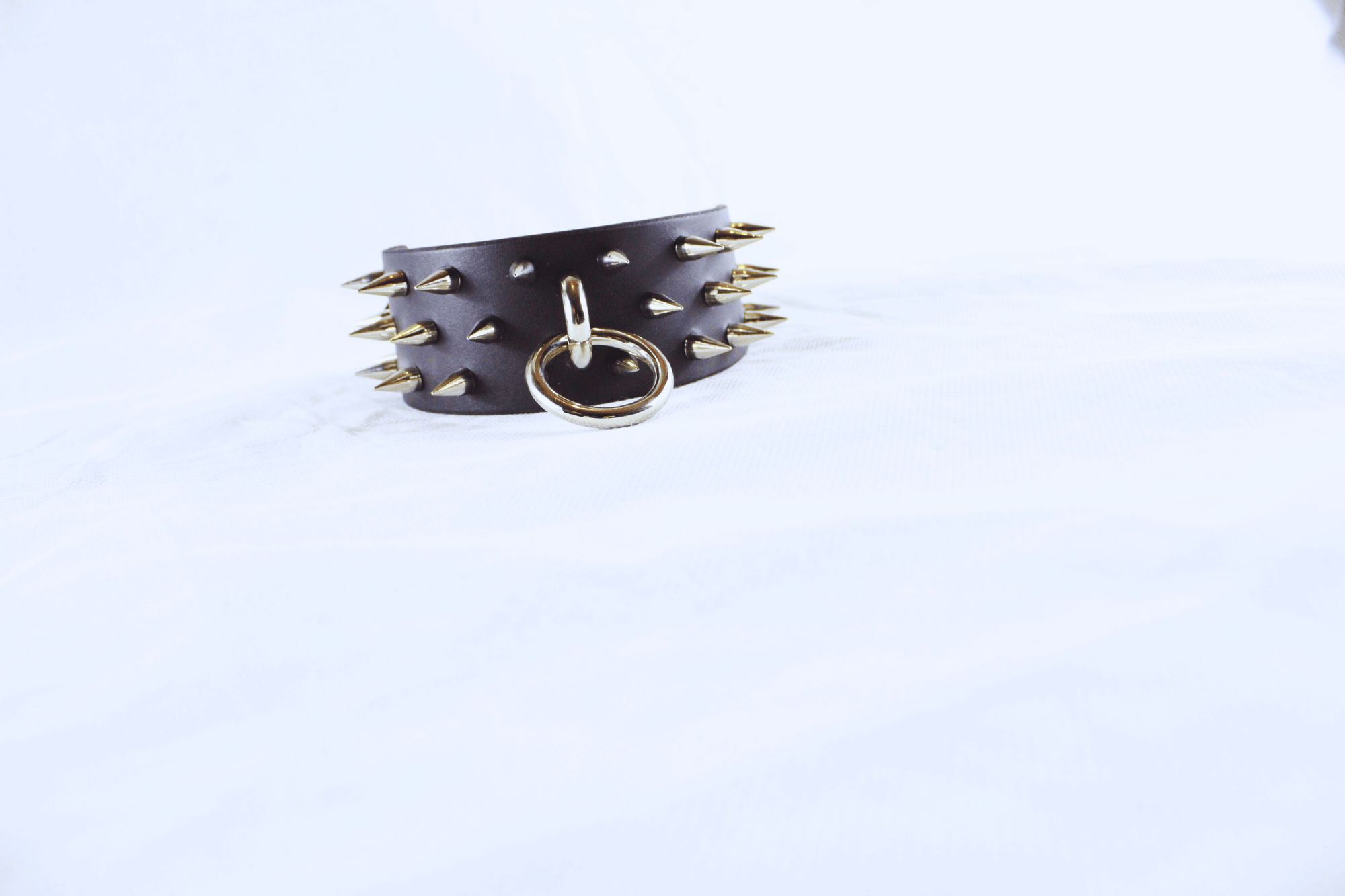 Dominion Leather Collar featuring sharp spikes and a metal D-ring for BDSM wear.