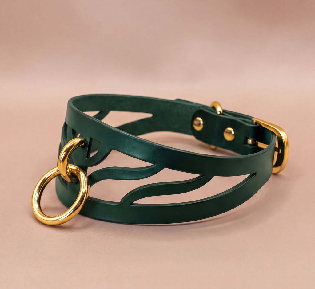 A green leather choker necklace with a gold-colored metal ring and buckle.