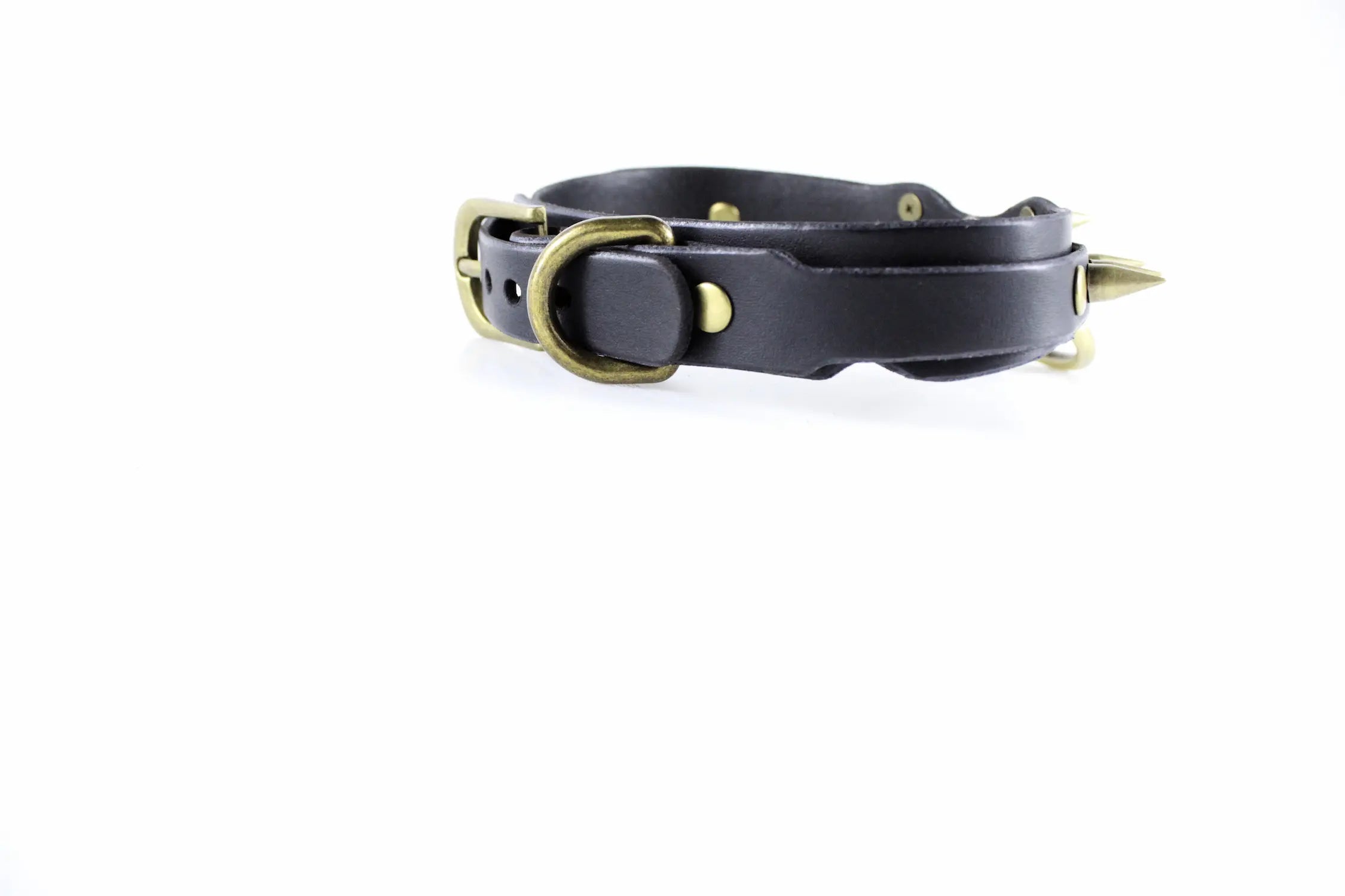 A black leather collar with a metal buckle and spikes protruding from it.