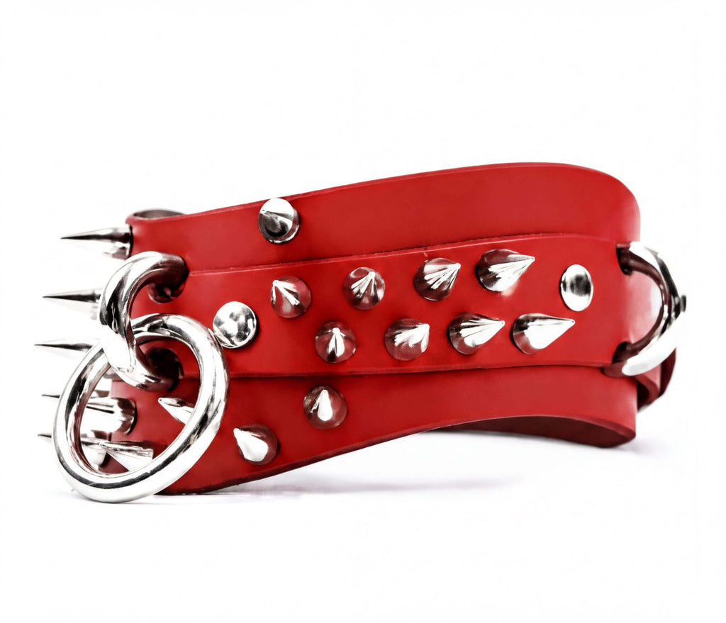 A red leather belt with silver spikes protruding from it.