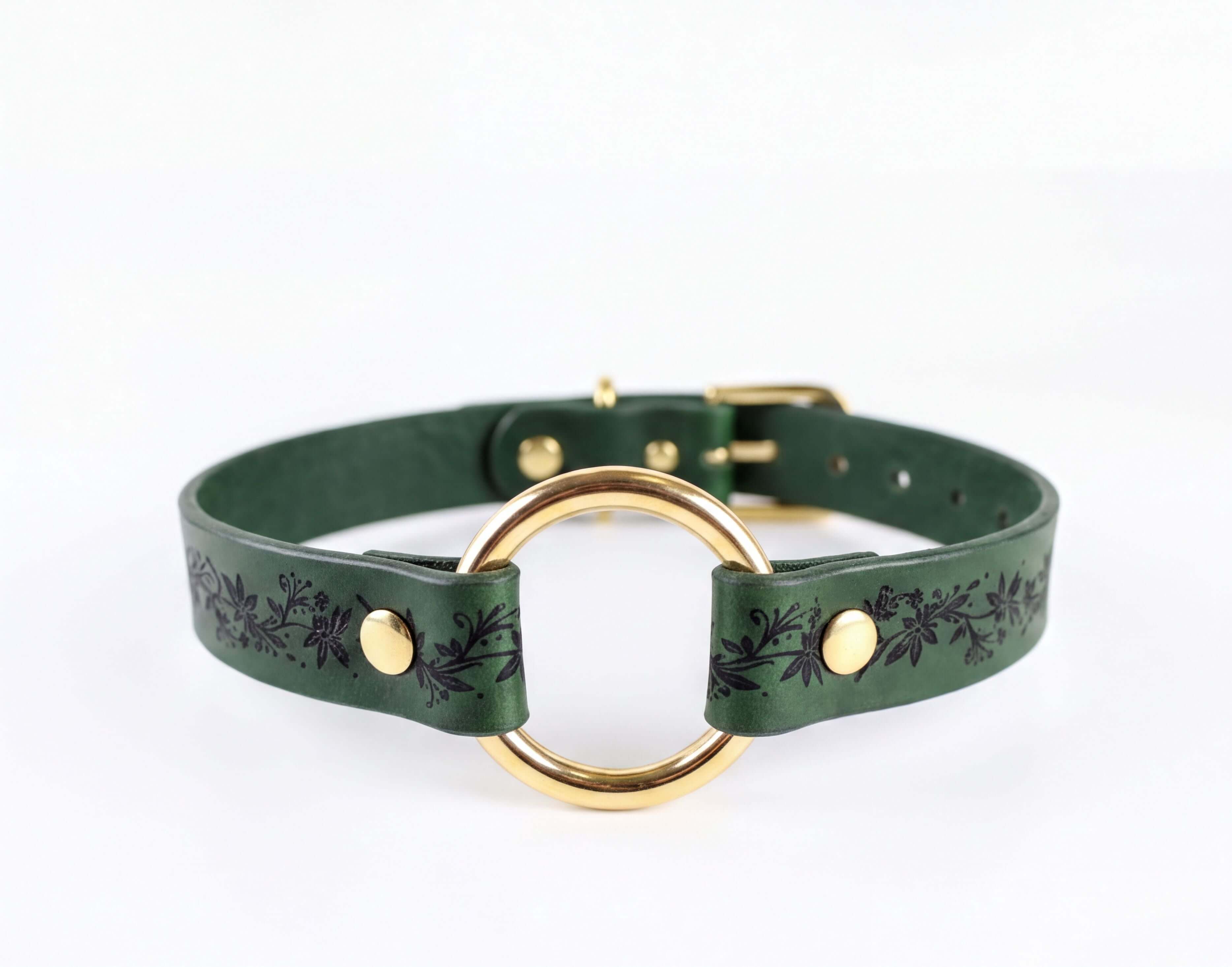 A green leather choker collar with a gold-colored circular buckle.