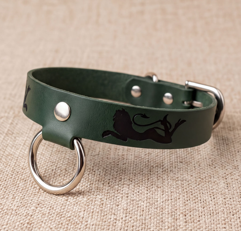A green leather dog collar with a silver metal ring and a black lion silhouette design.