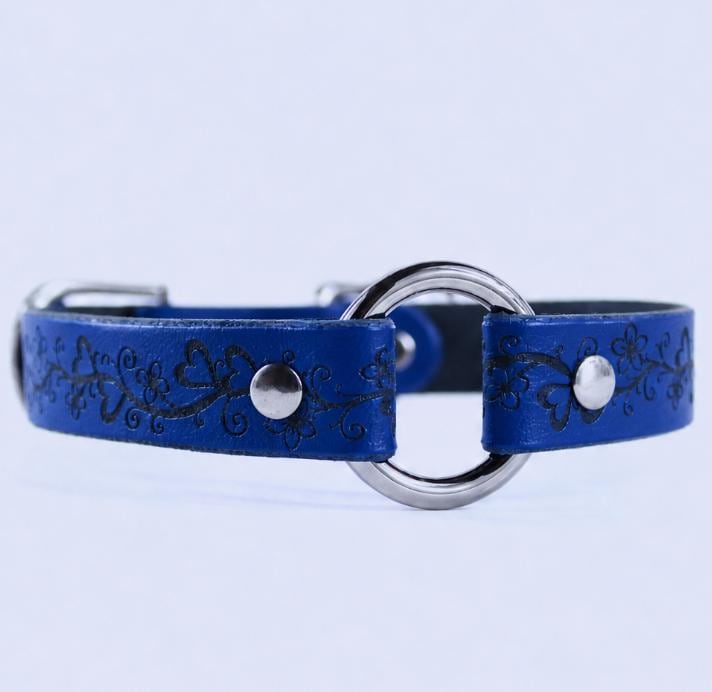 A blue leather collar with a silver metal ring and decorative floral patterns.