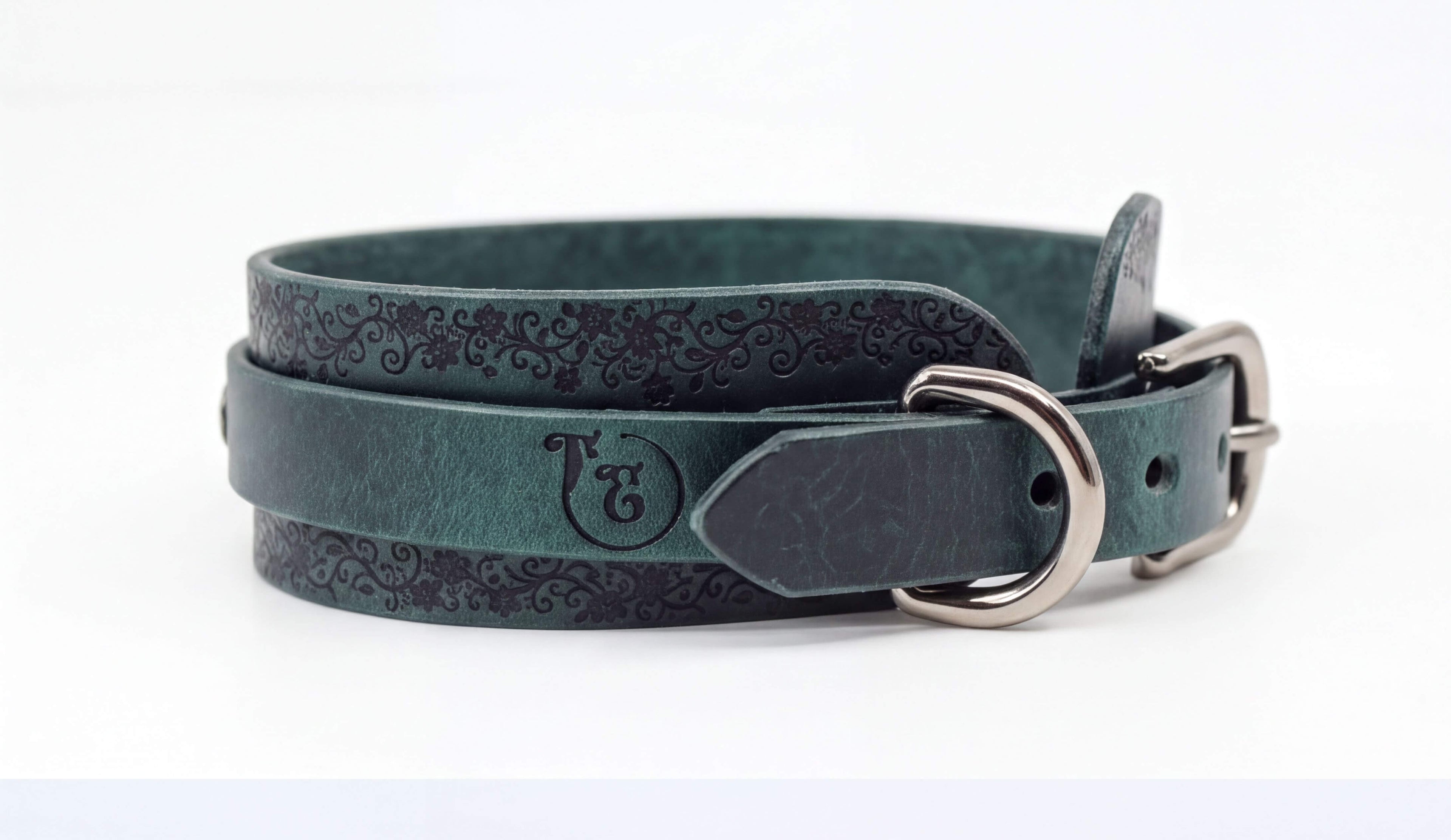 A dark green leather belt with a metal buckle, featuring a decorative pattern on the surface.