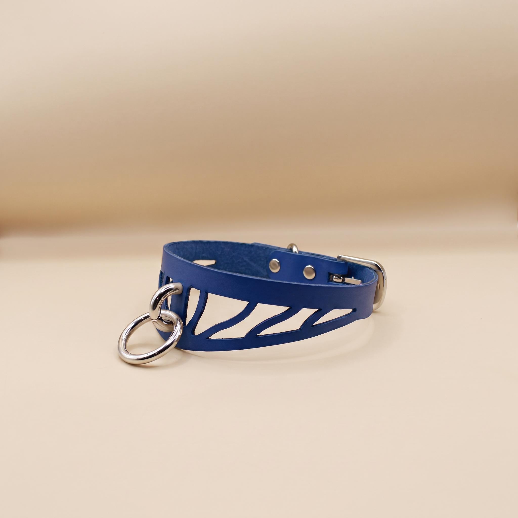 A blue leather choker necklace with metal rings and a metal clasp.