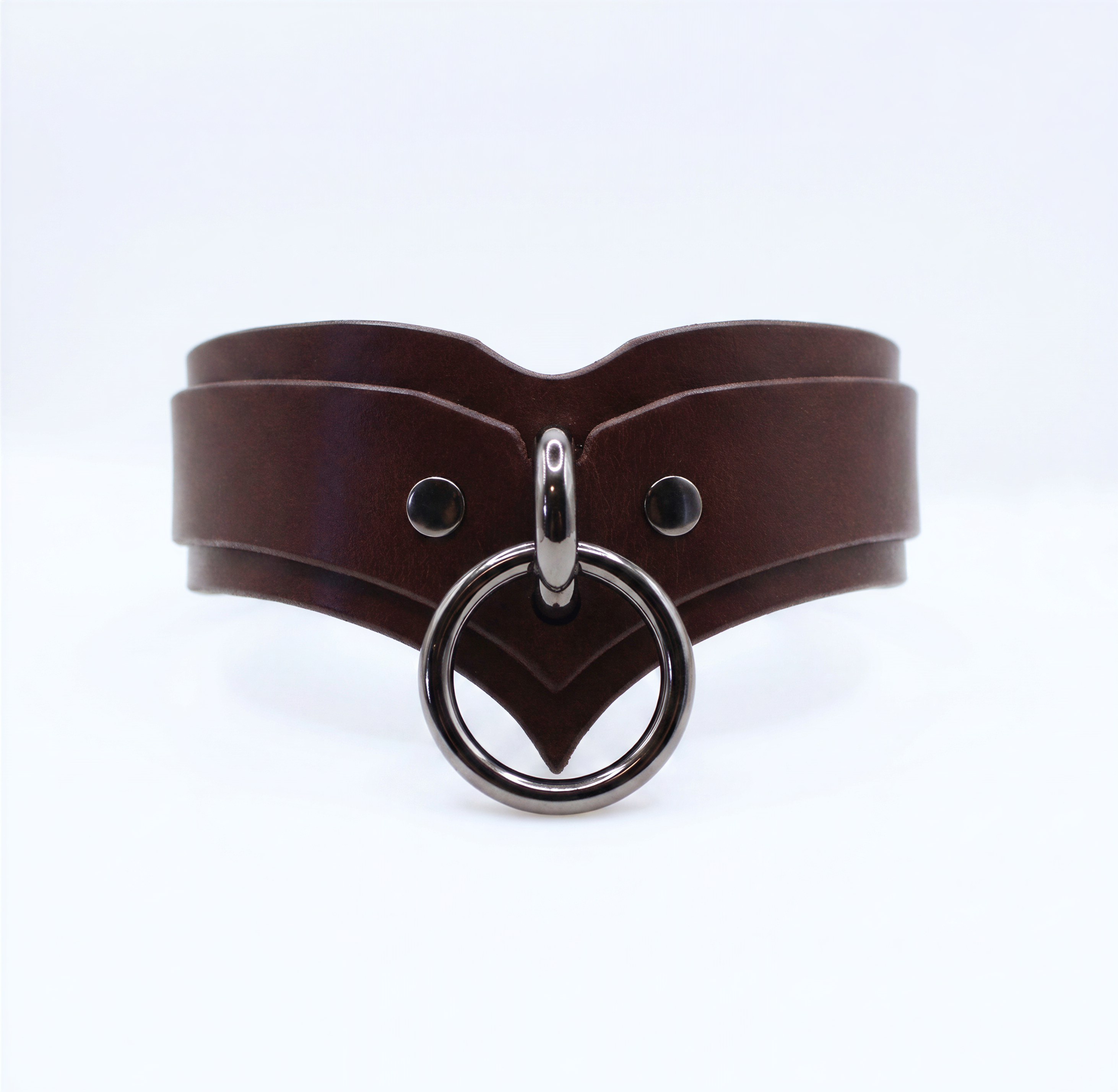 A brown leather choker necklace with a metal ring and two circular buttons.