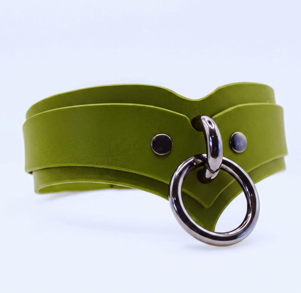A green leather choker necklace with a silver metal ring and two circular buttons.