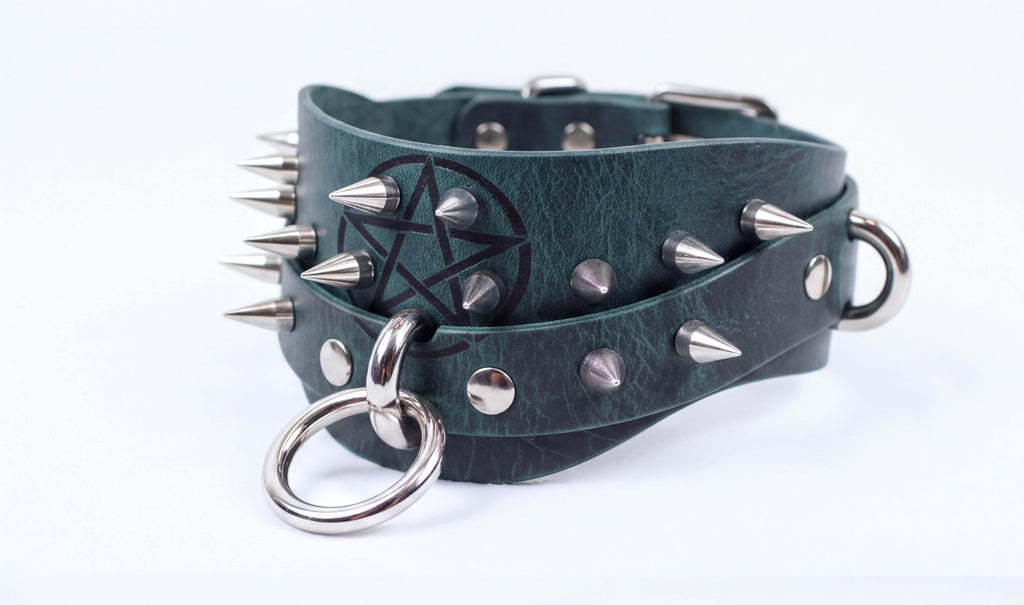 A green leather choker necklace with spikes and a pentagram design.