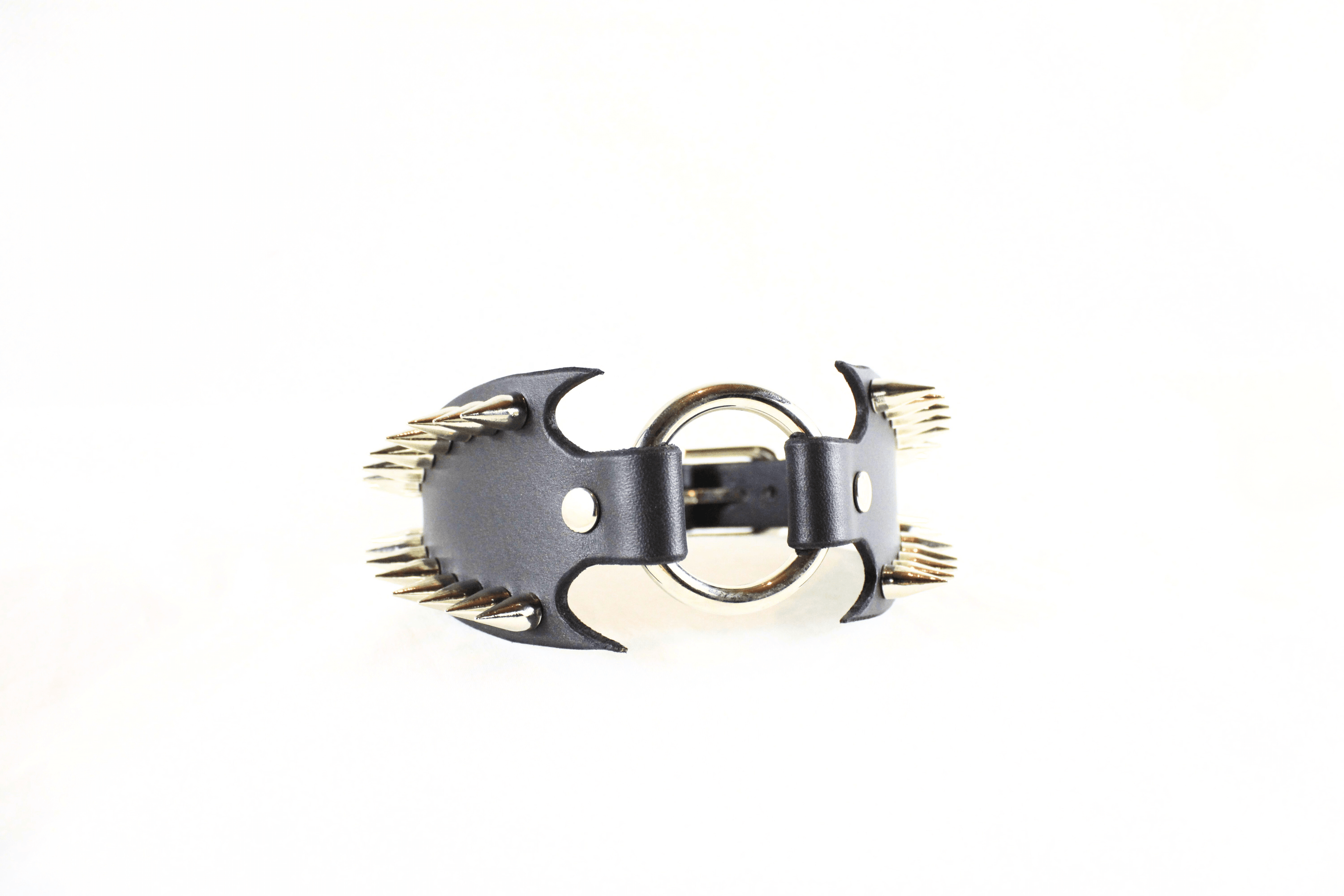 Leather Submissive Collar with spiked edges and metal ring centerpiece, embodying gothic style and BDSM aesthetics.