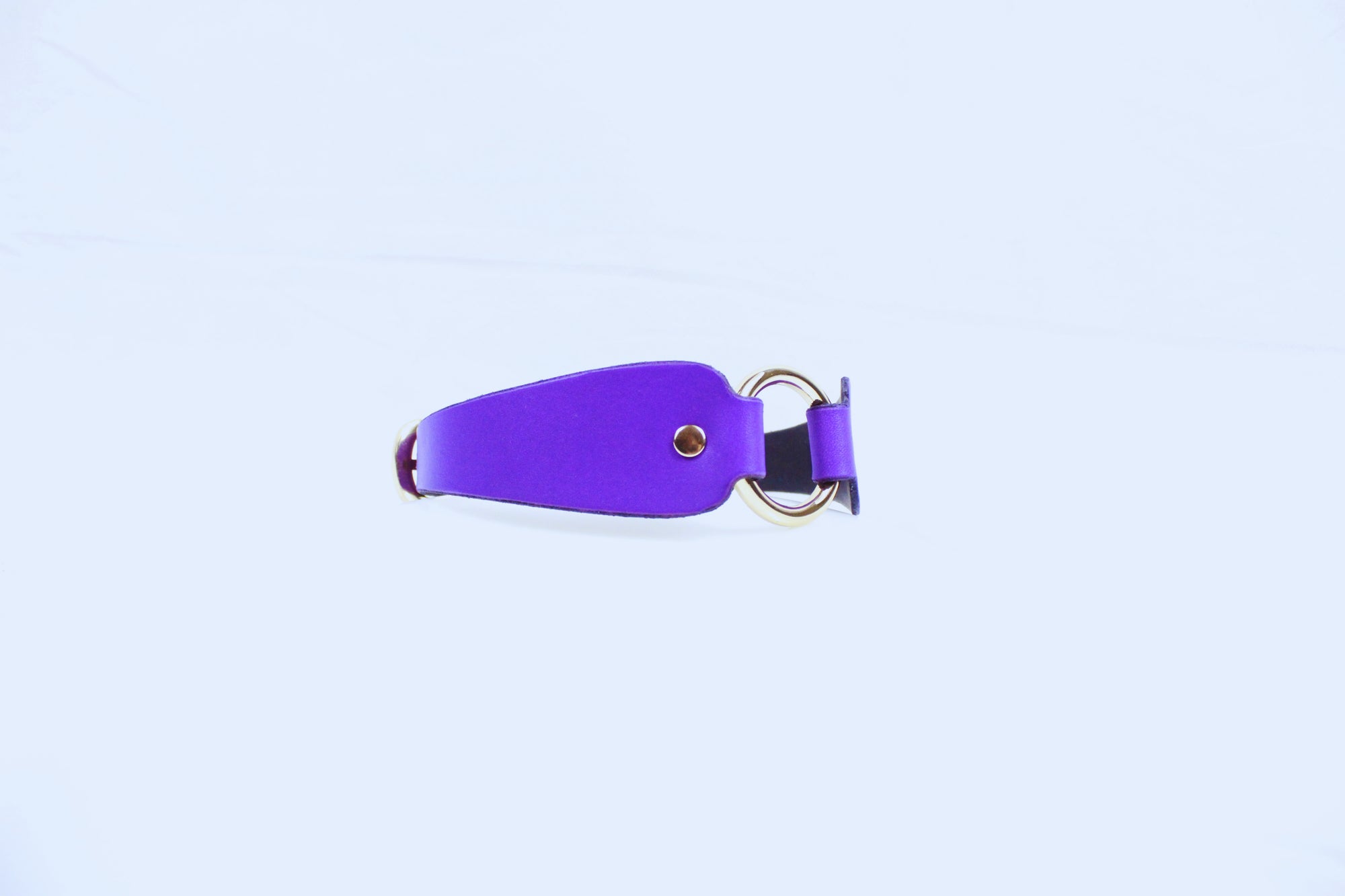 A purple leather strap with a metal buckle is shown against a plain white background.