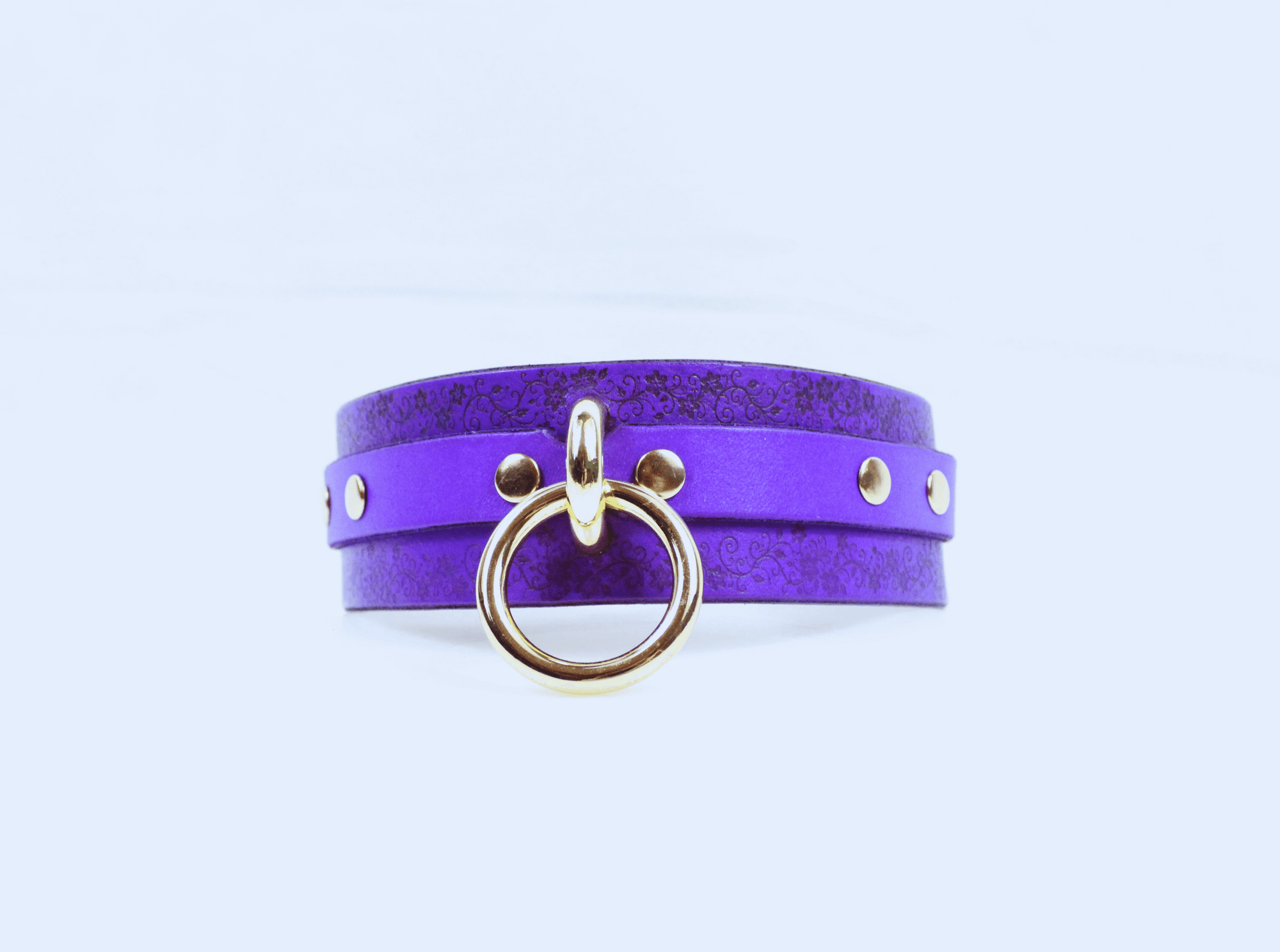 Floral Pattern Submissive Collar in purple leather with gold ring and studs, perfect for discreet day wear.
