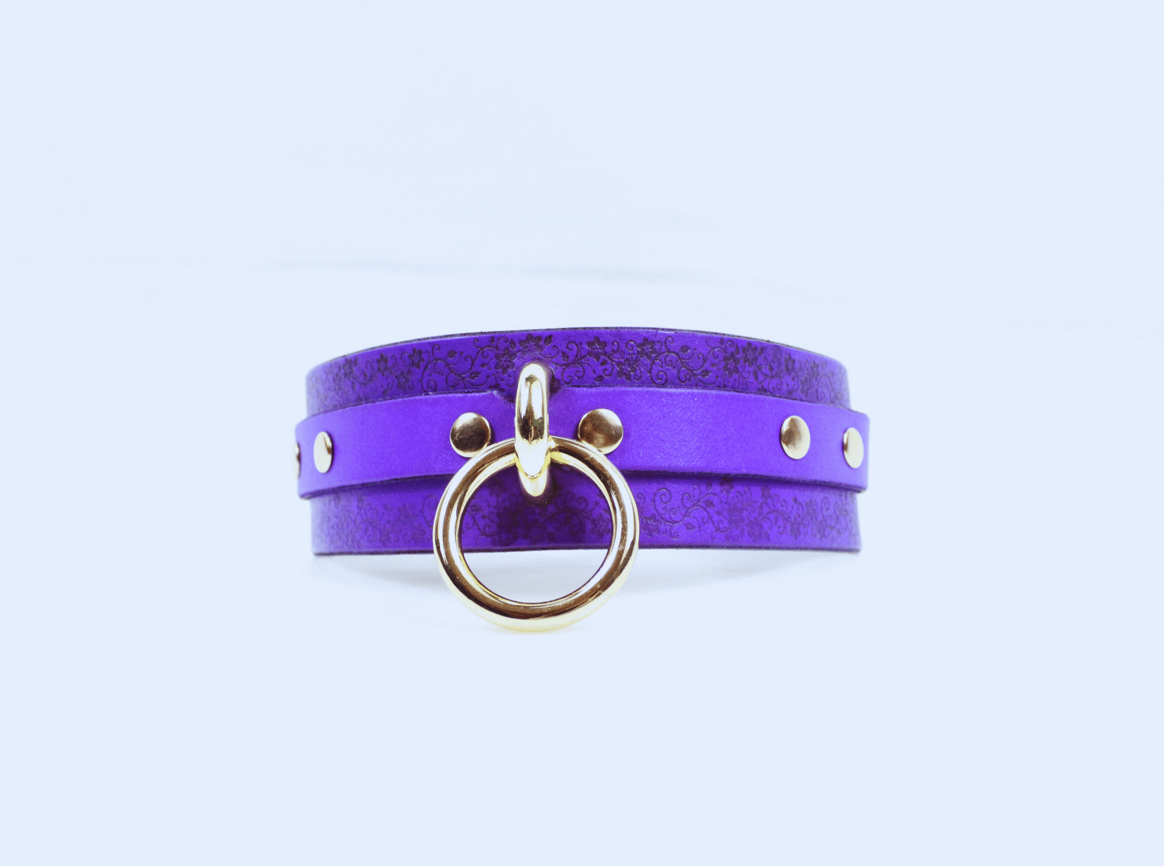 Floral Pattern Submissive Collar in purple leather with gold ring and studs, perfect for discreet day wear.