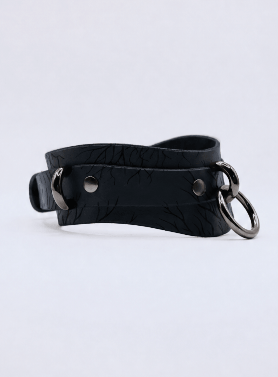 A black leather choker necklace with metal rings and a metal clasp.