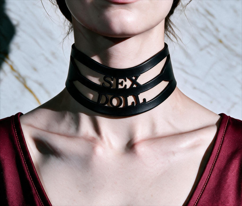 A close-up of a person wearing a black choker necklace with the word "SEX" printed on it.