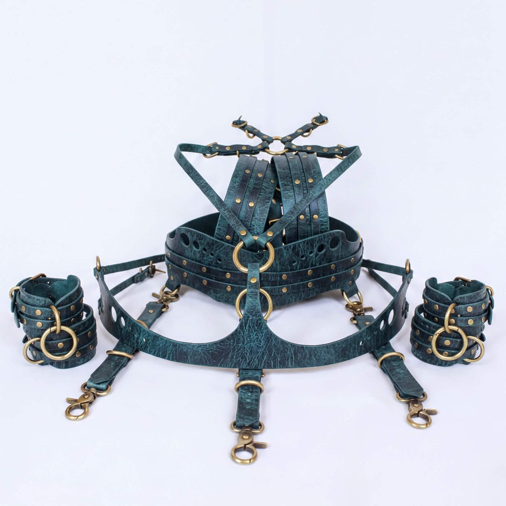 A set of dark green leather straps with gold-colored buckles and clasps, arranged in a circular pattern.
