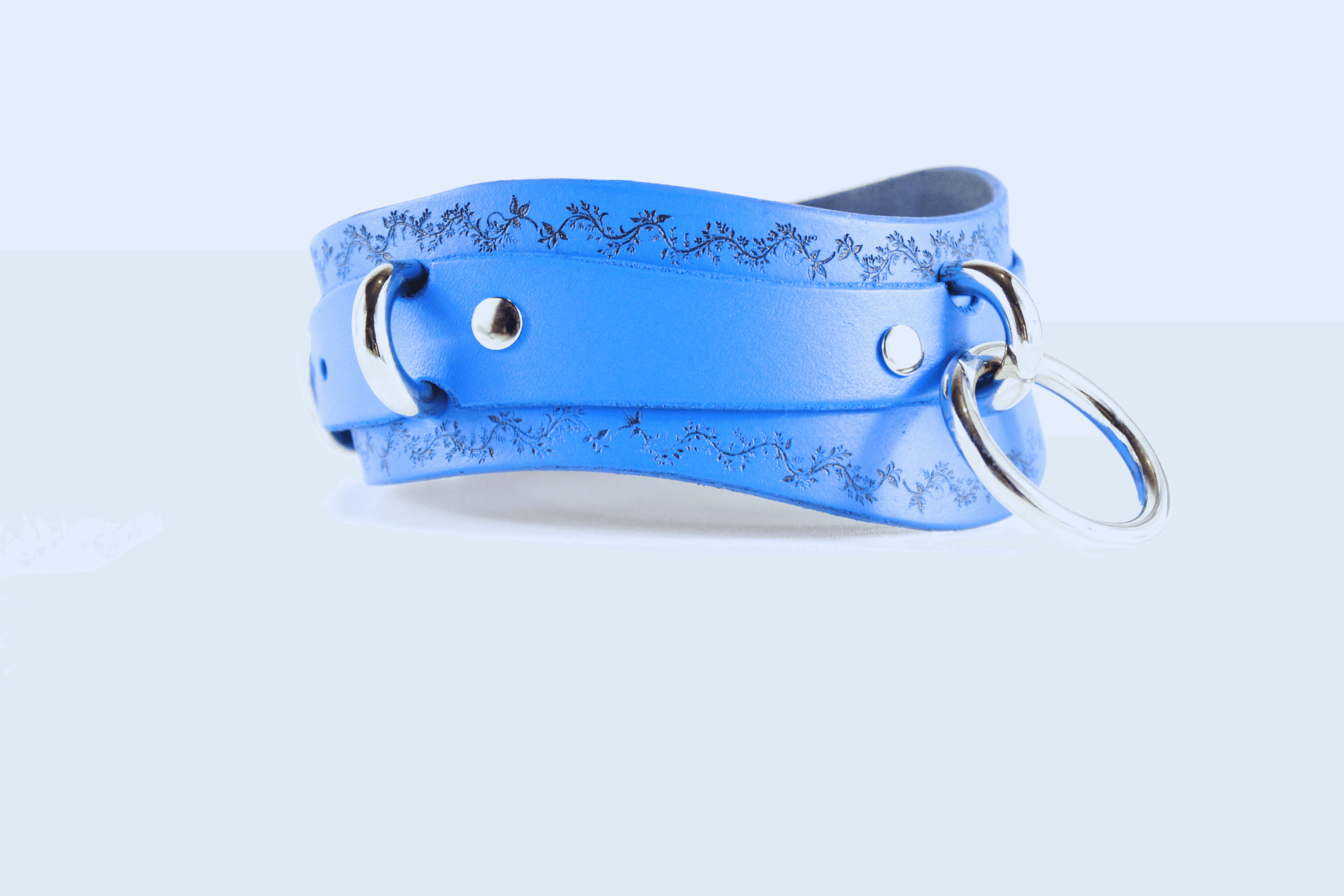 Floral Vine Posture Collar in blue leather with floral motif and O-ring detailing.
