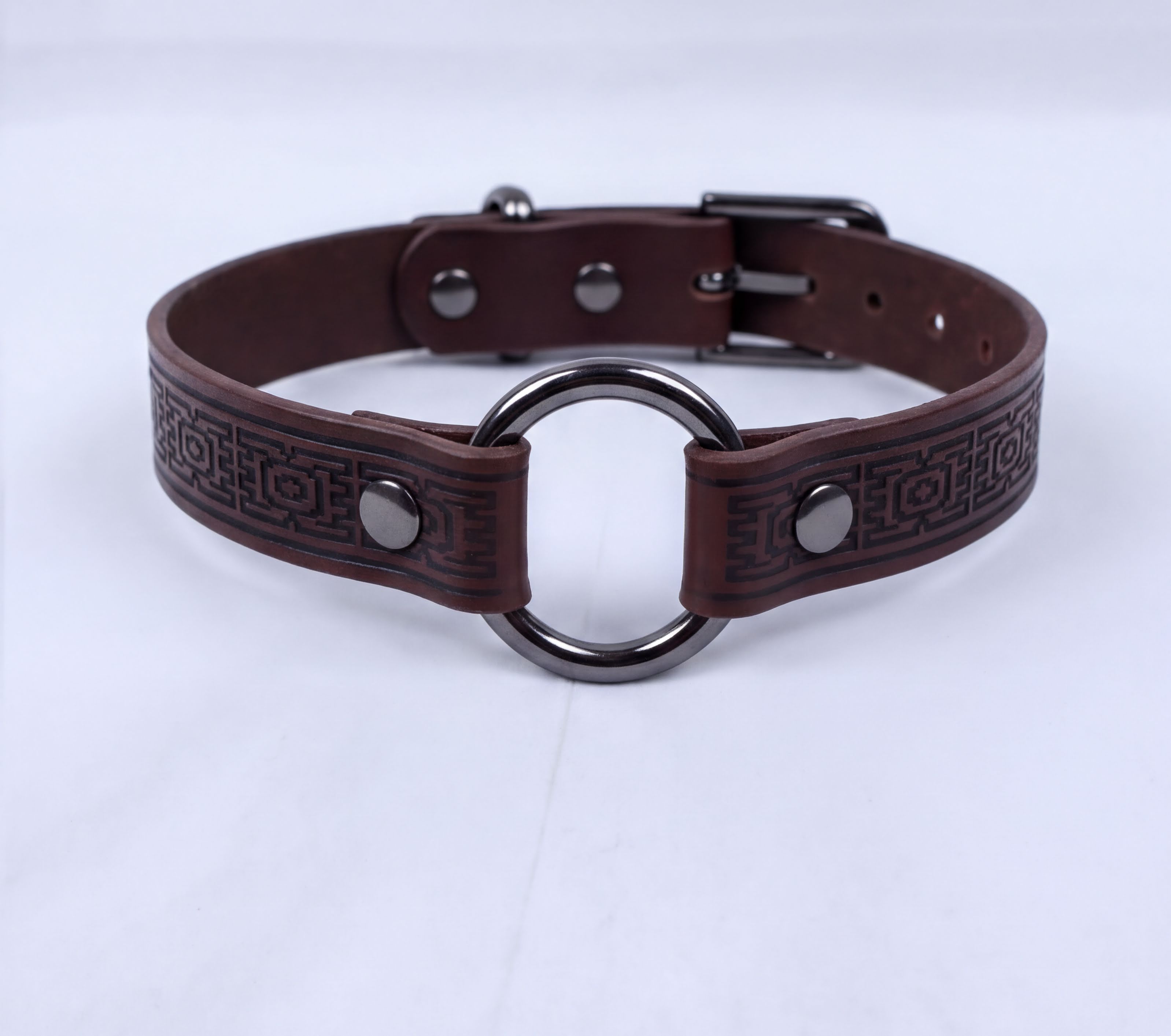 A brown leather choker collar with a metal ring and buckle.