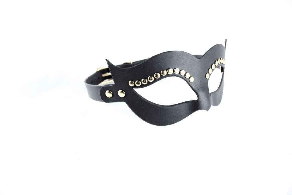 A black leather mask with gold studs on the sides.