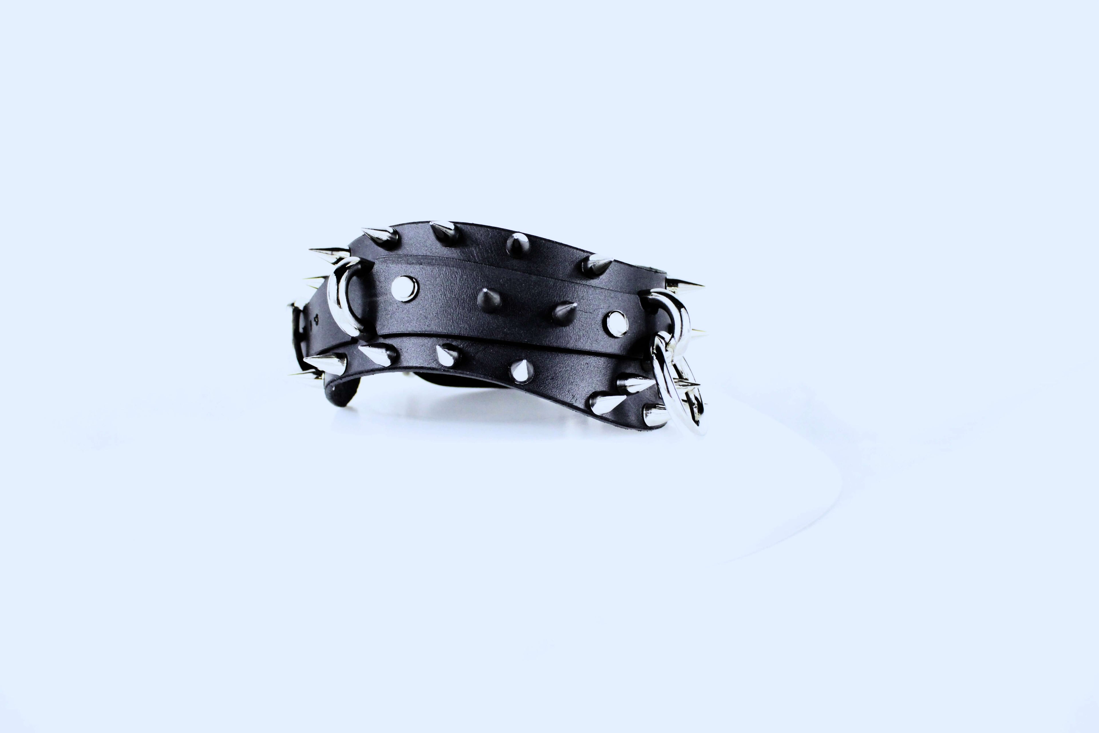 Spiked BDSM Collar showcasing a black leather design with silver spikes and a secure fastening.