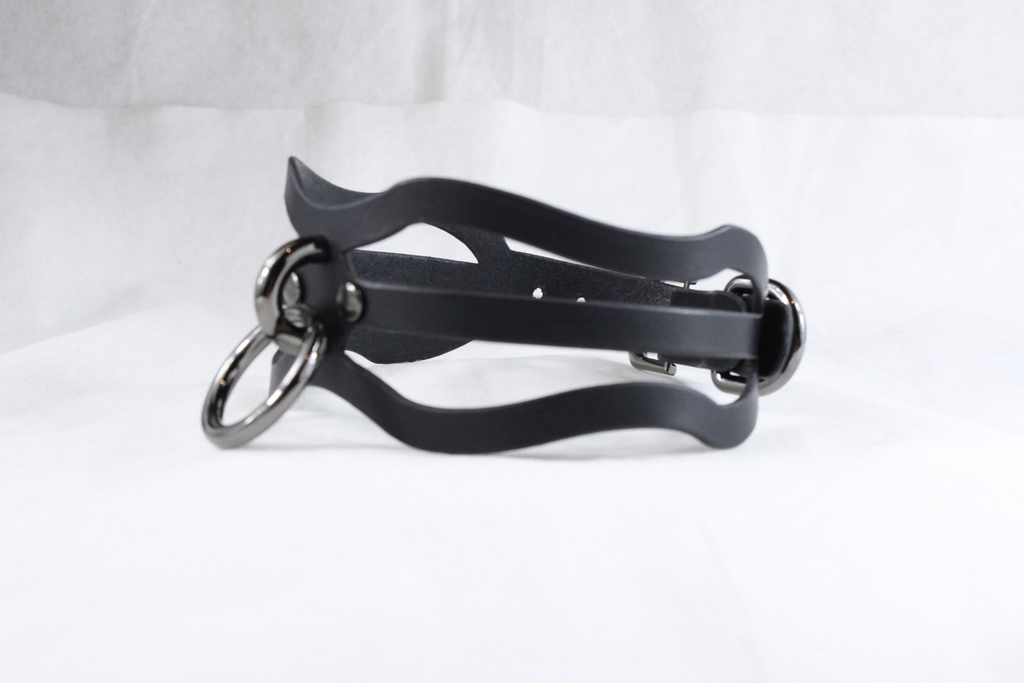 A black leather choker necklace with metal rings and a curved clasp.