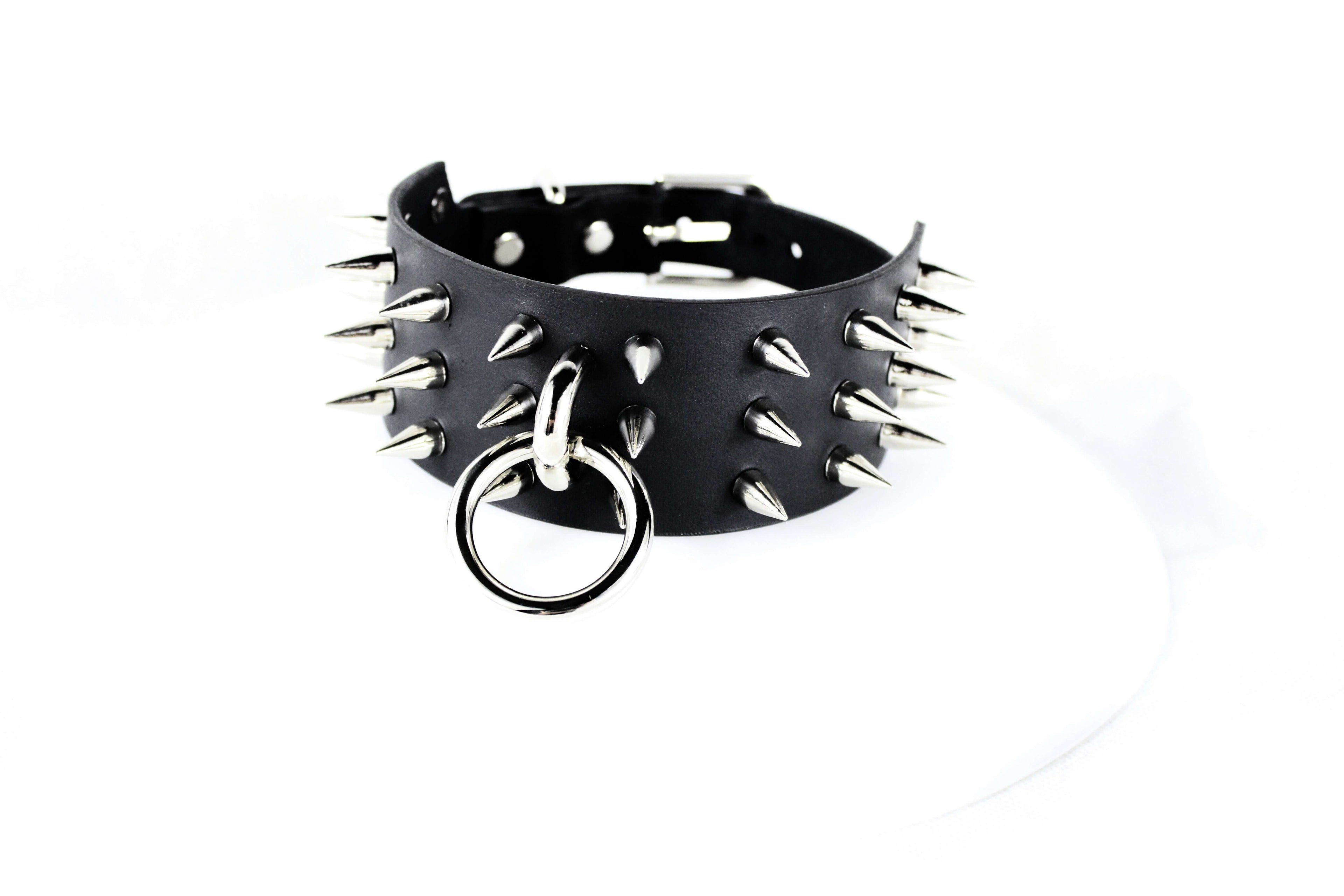 Black Spiked BDSM Collar – Leather Submissive Collar with O-Ring, featuring polished metal spikes.