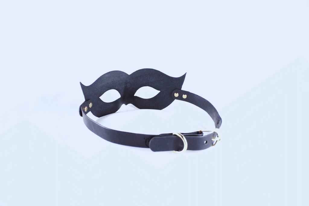 Leather Bondage Mask in black with elegant curves and adjustable strap for a striking look.