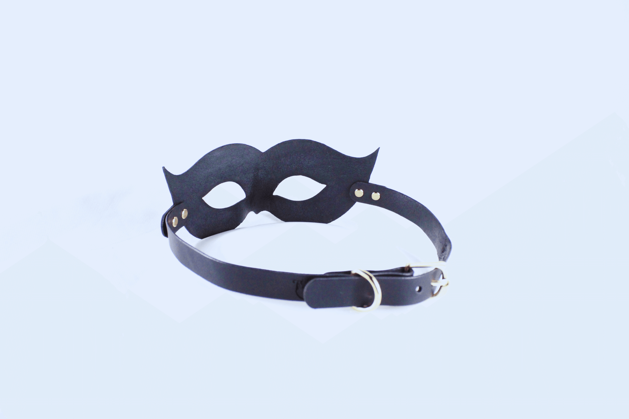 Leather Bondage Mask in black with elegant curves and adjustable strap for a striking look.