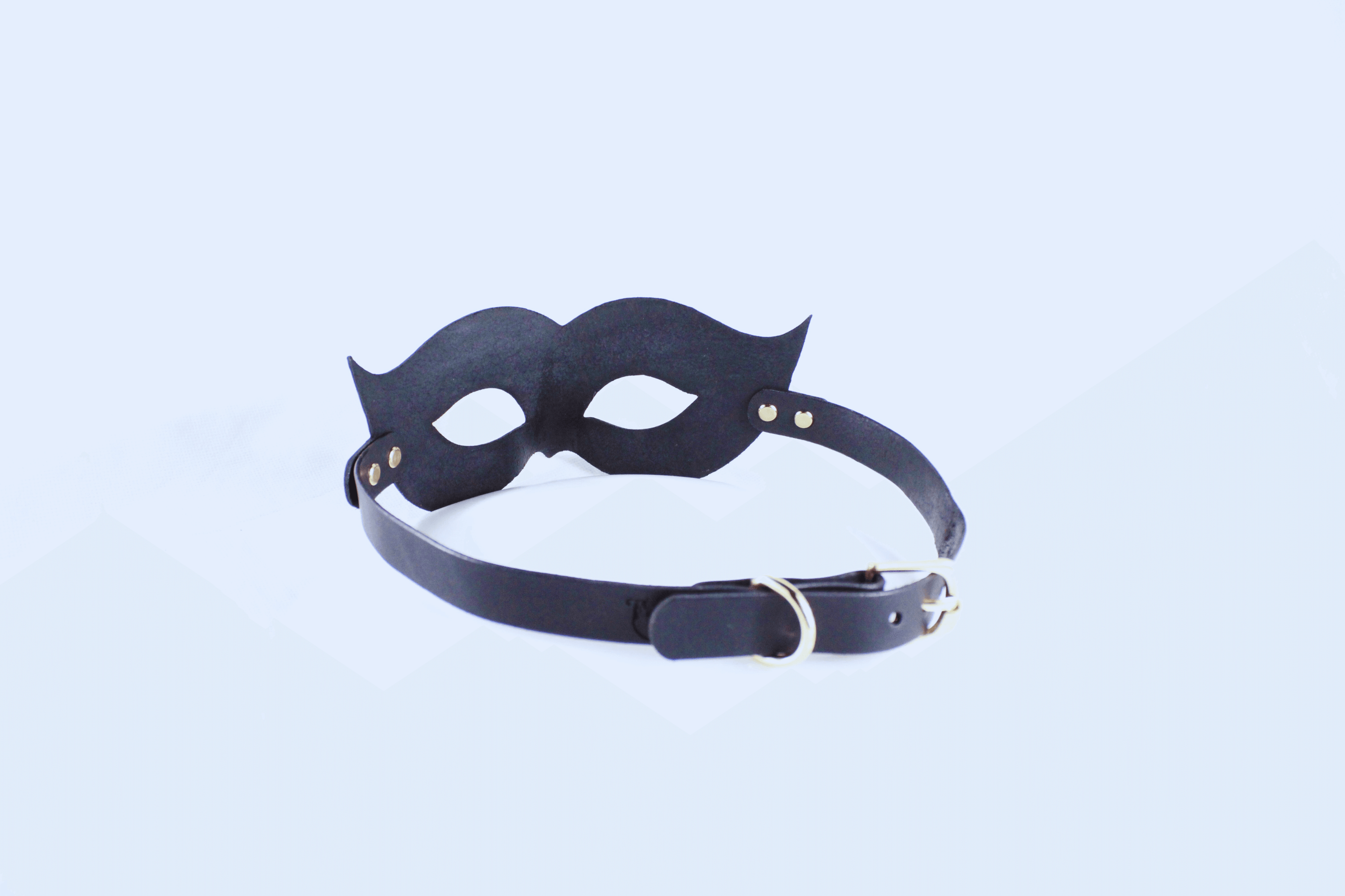 Leather Bondage Mask in black with elegant curves and adjustable strap for a striking look.