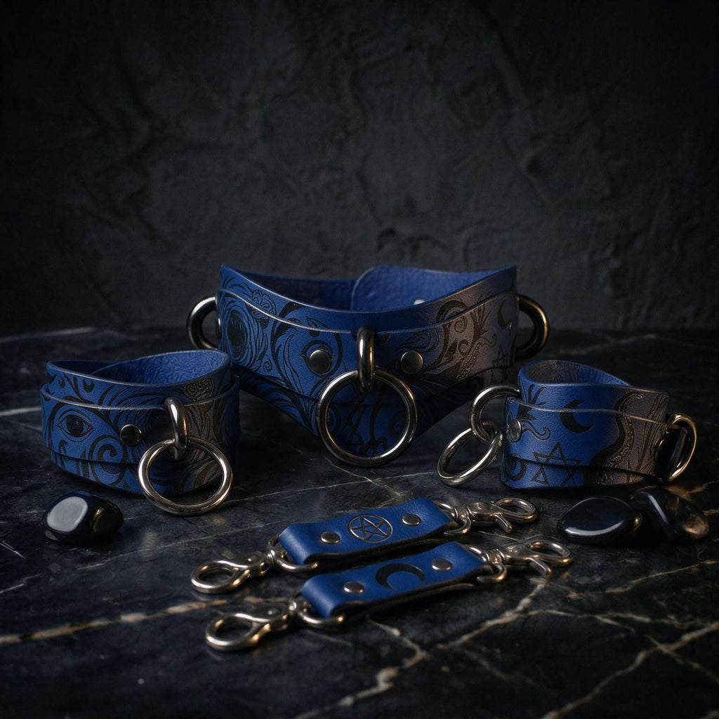 A collection of blue leather straps with metal rings and buckles, arranged on a dark surface.