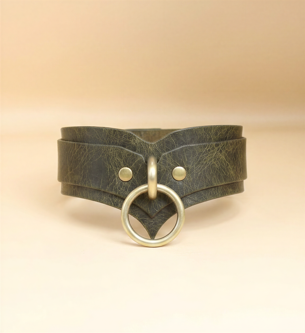 A dark green leather choker collar with a brass ring and two small holes on the front.