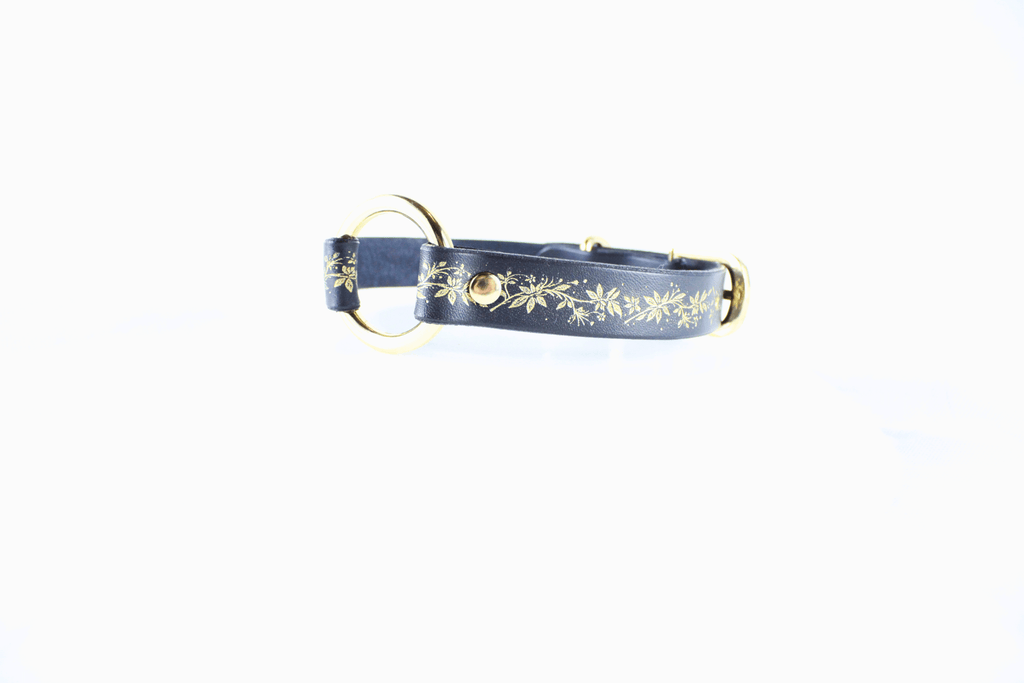Black Leather Fetish Collar with golden floral pattern and O-ring, perfect for bondage or as jewelry.