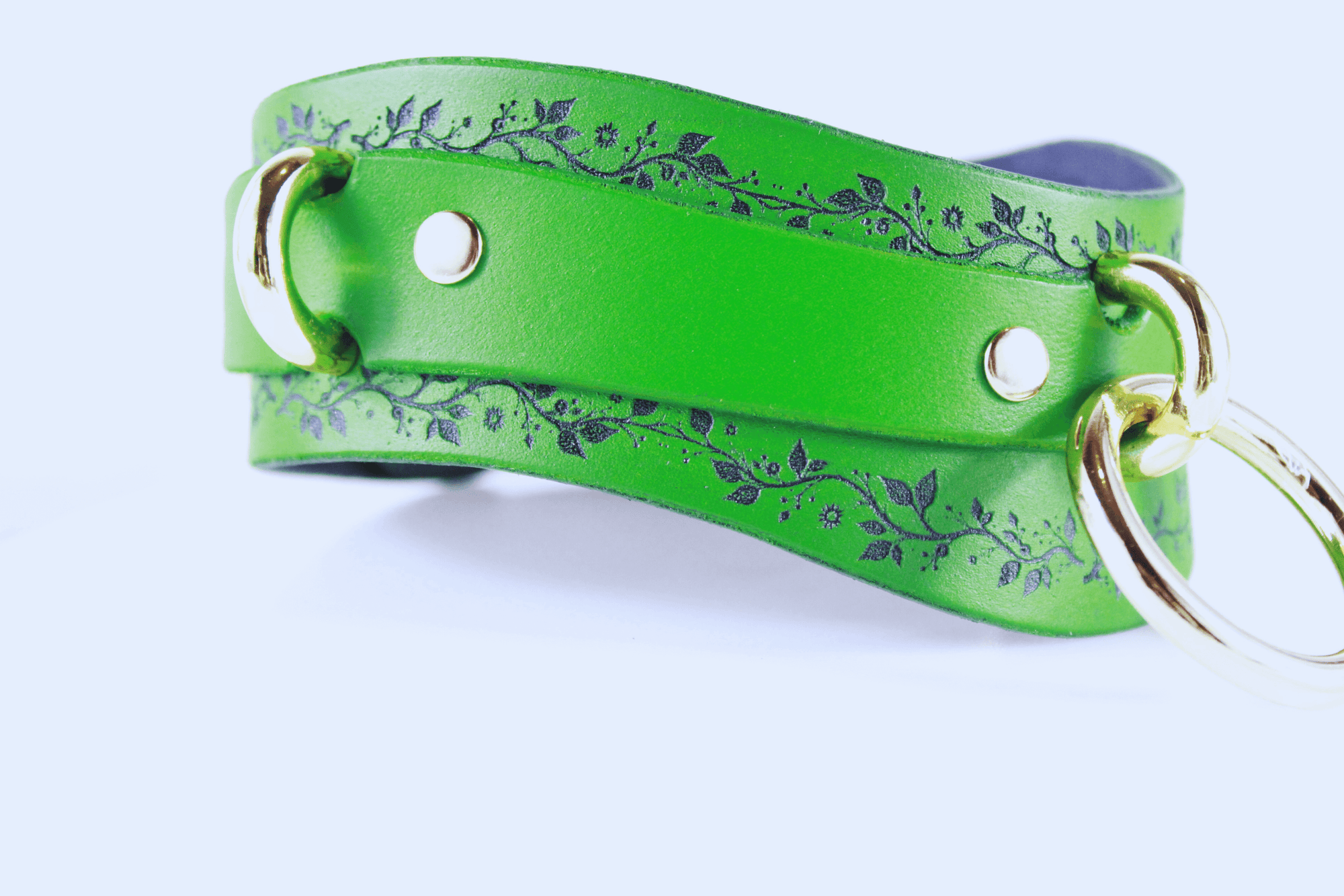 Green Vine Leather Submissive Collar featuring a delicate vine pattern and polished rings.