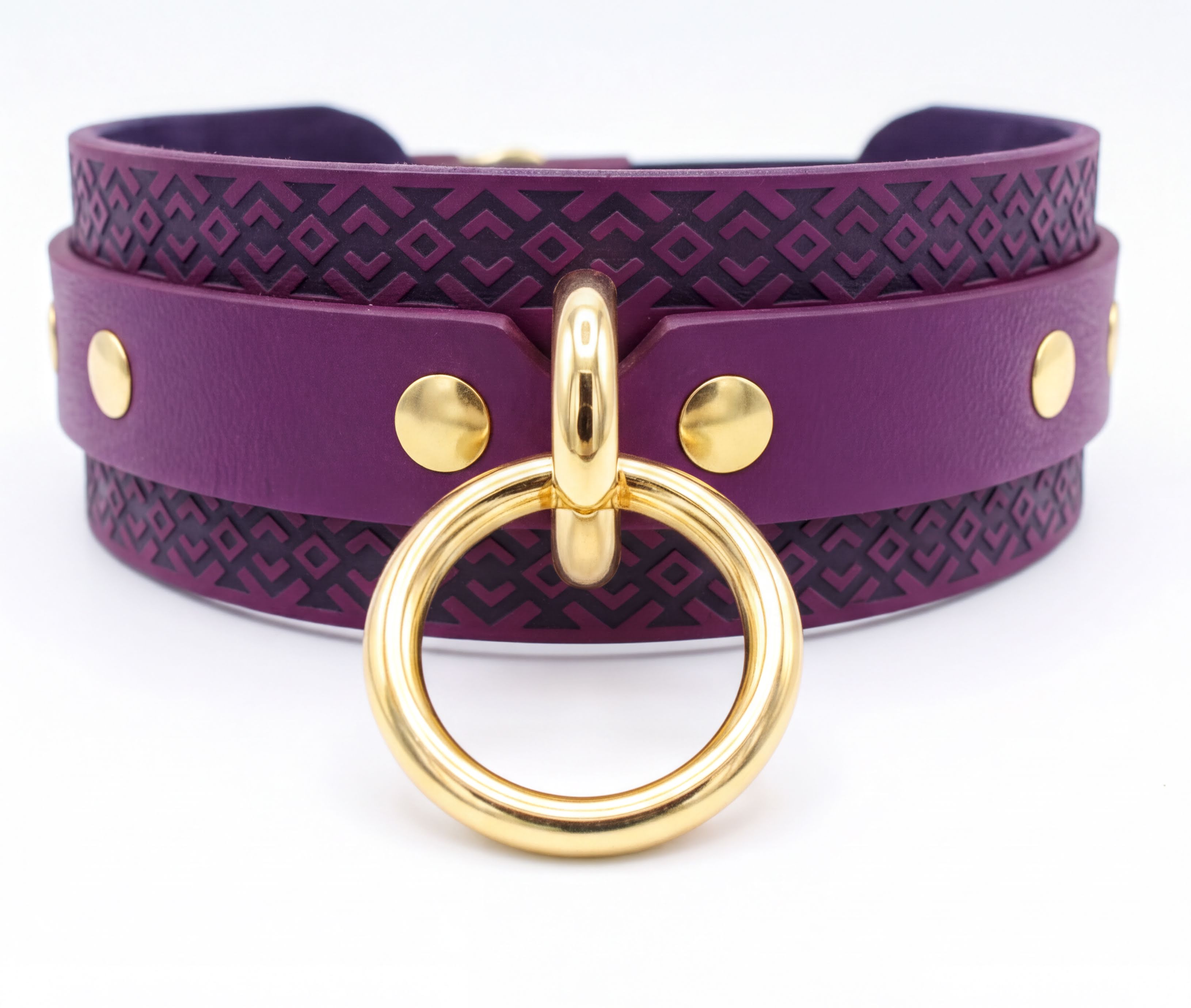 A purple leather choker necklace with a gold ring and studs on the front.