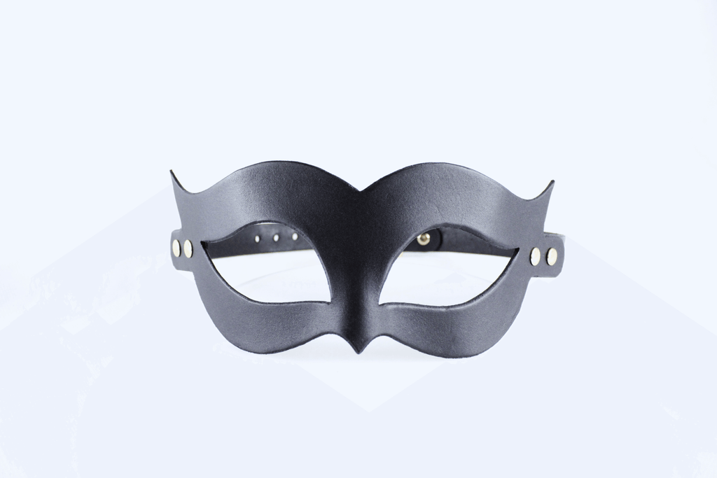 A black mask with a unique, cat-like design is shown against a white background.