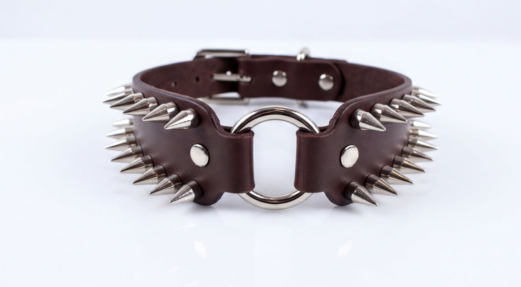 A close-up image of a leather choker necklace with spikes protruding from it.