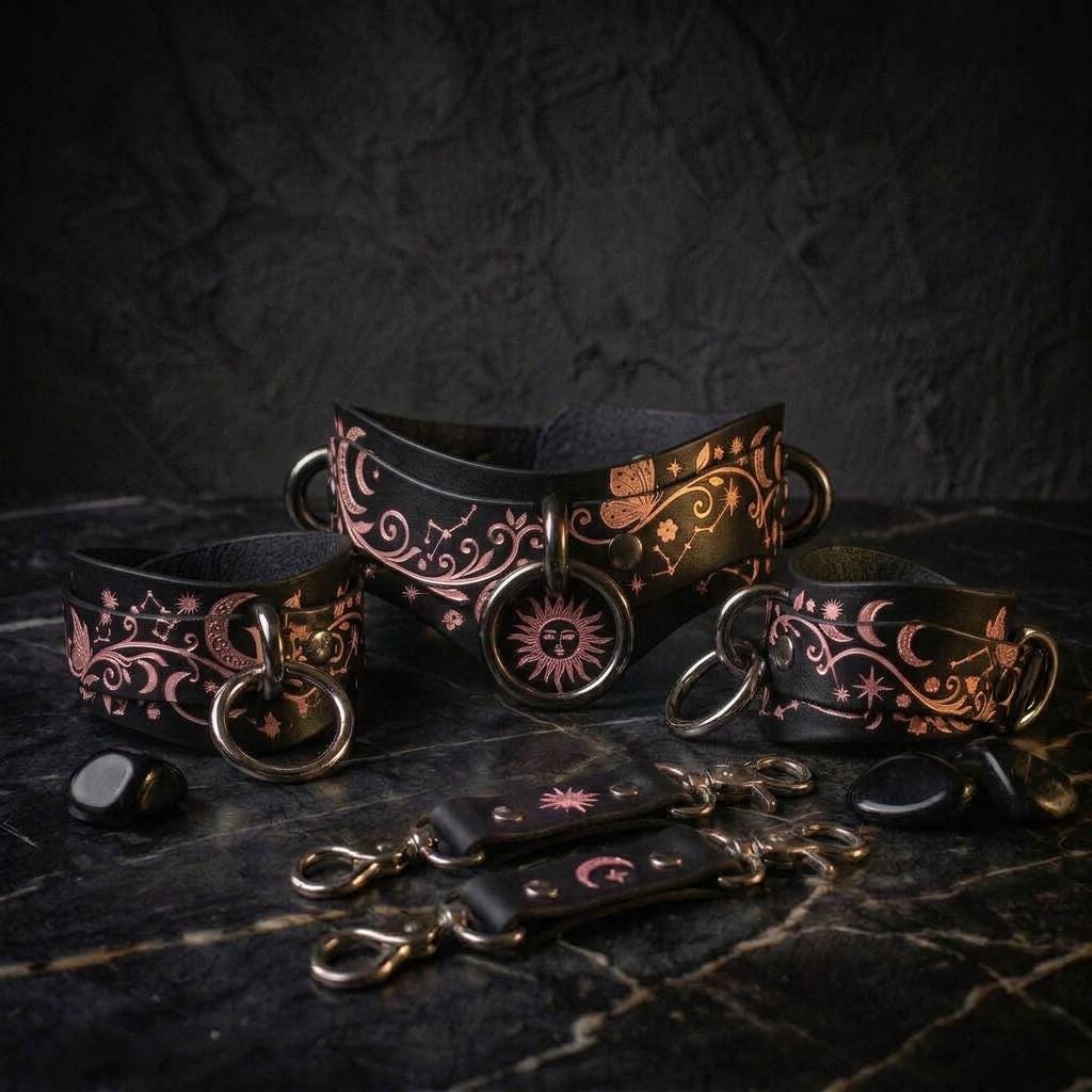 a collection of black leather accessories with intricate designs, including a collar, bracelets, and charms, all set against a dark background.