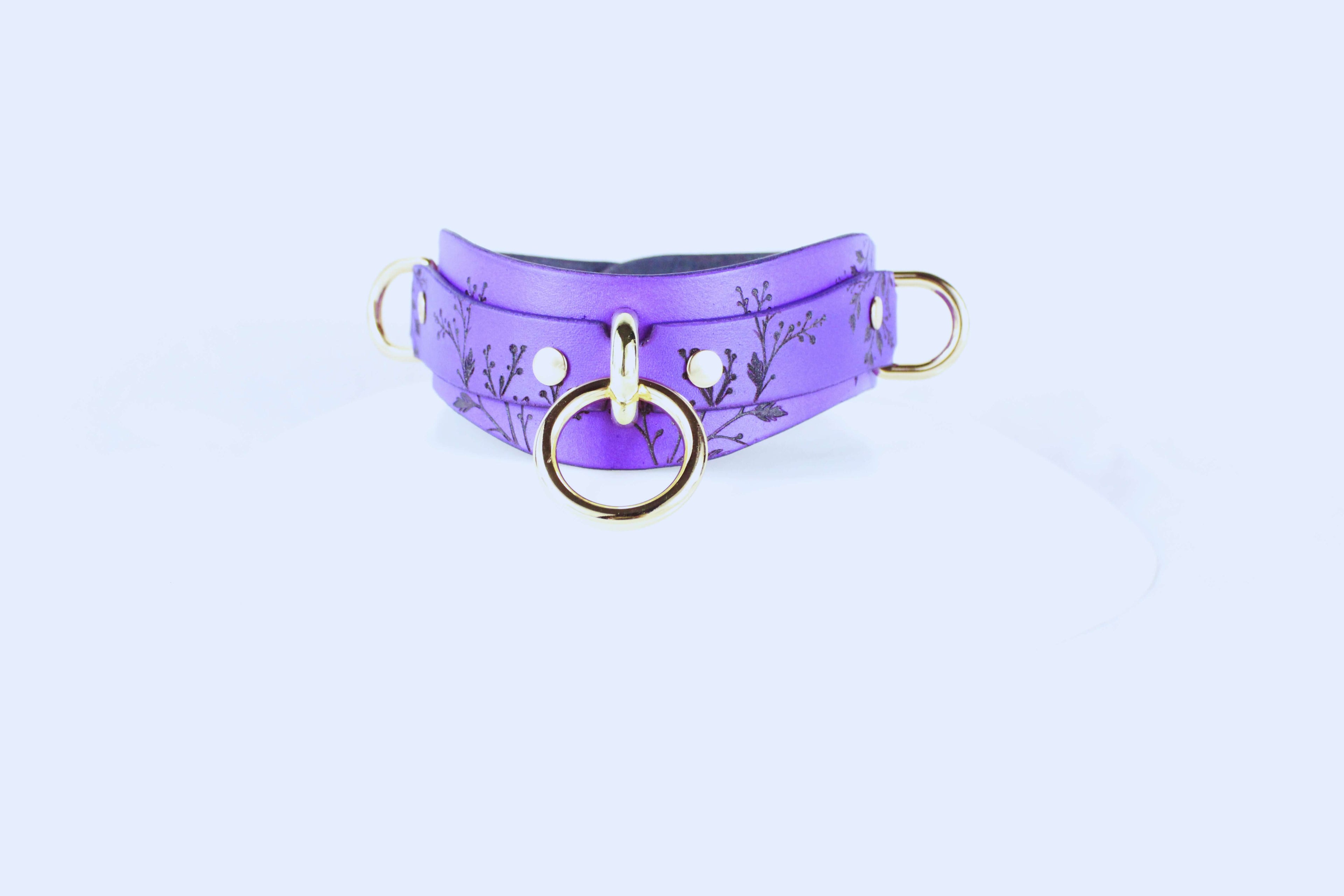 Purple Floral Submissive Collar with Gold O-Ring – Elegant BDSM Choker showcased against a soft backdrop.