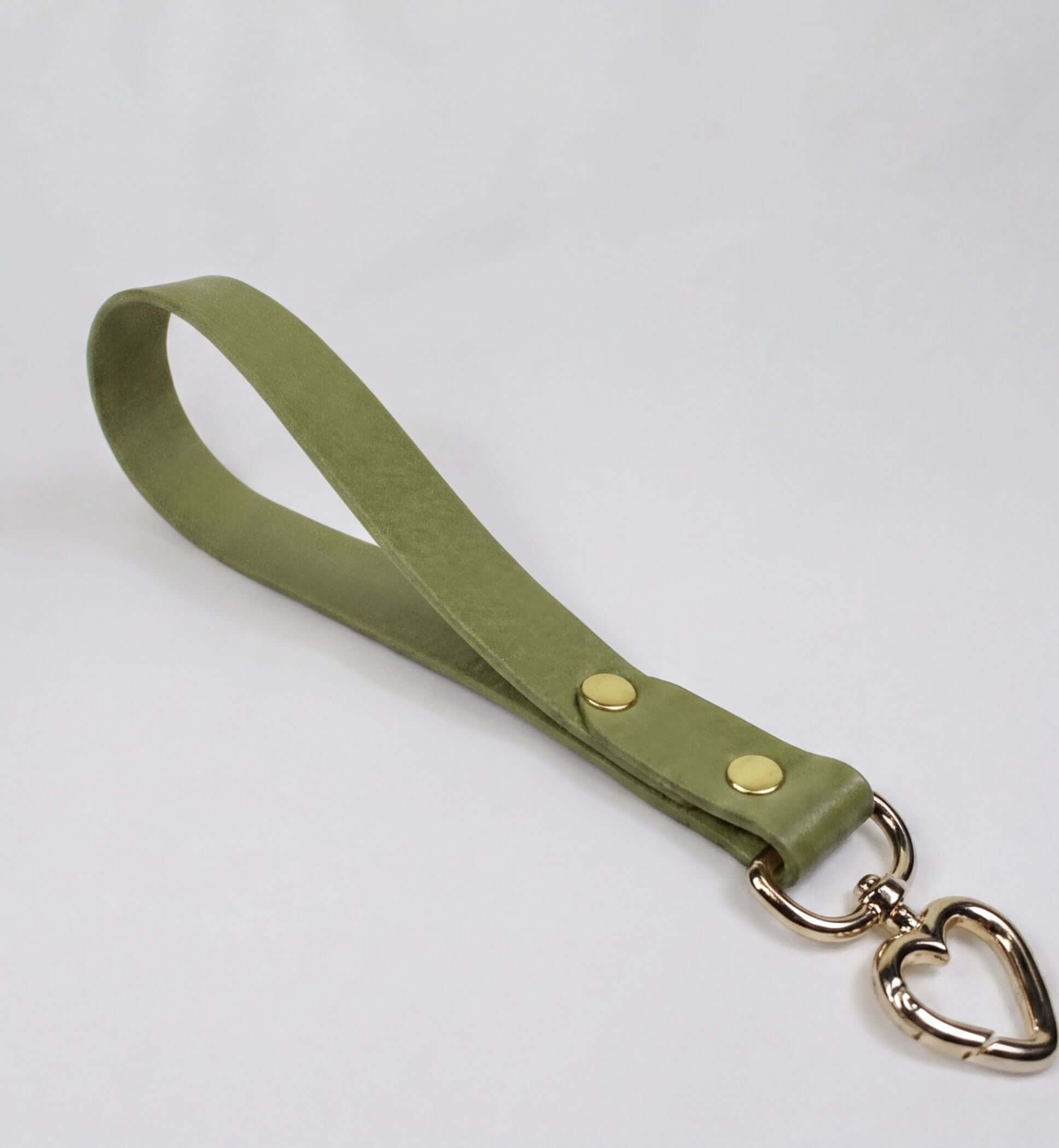 A green leather strap with a heart-shaped metal clasp attached to it.