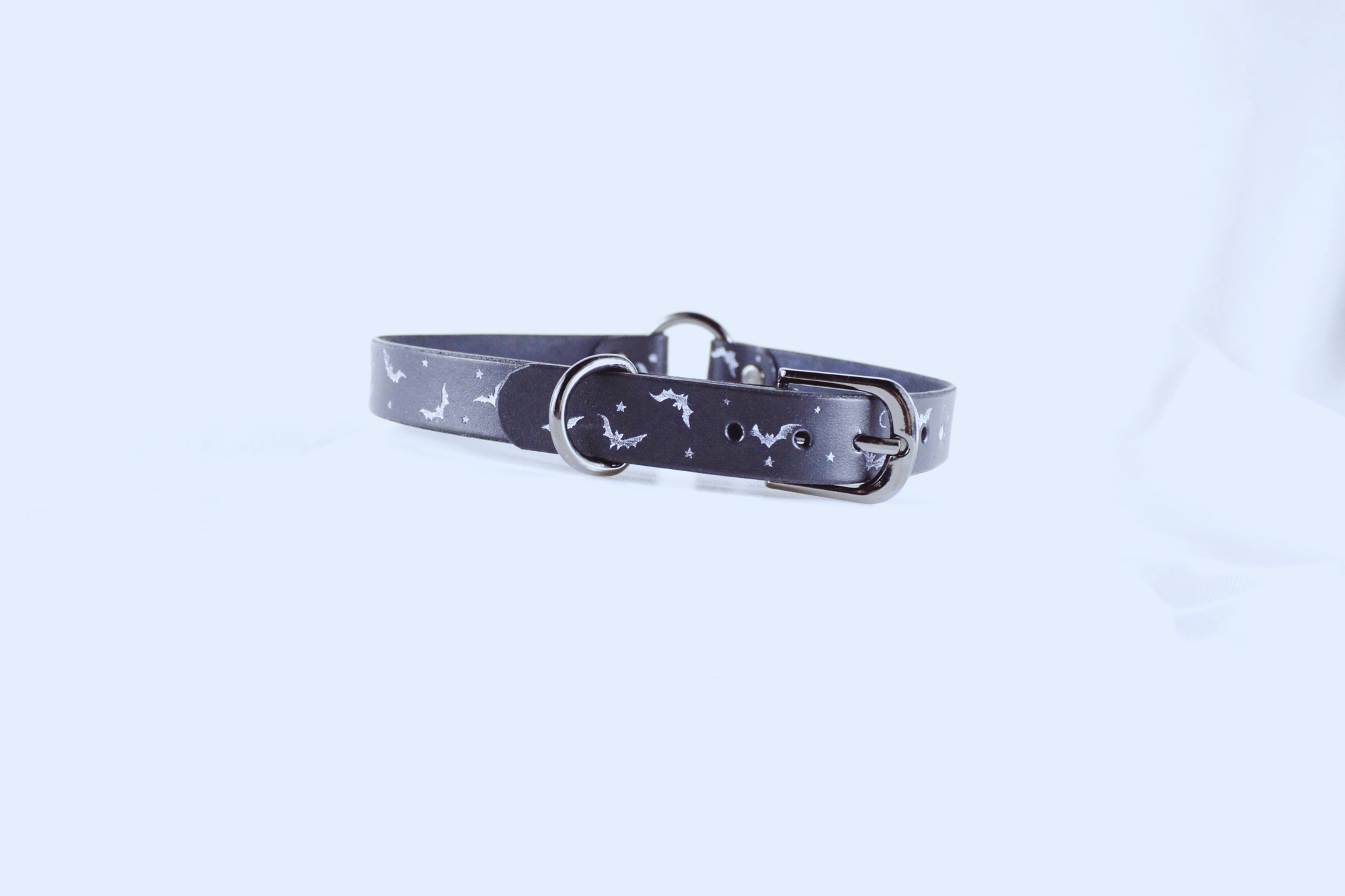 Bat and Moon Leather Choker displaying bats, moons, and stars on a sleek black design.
