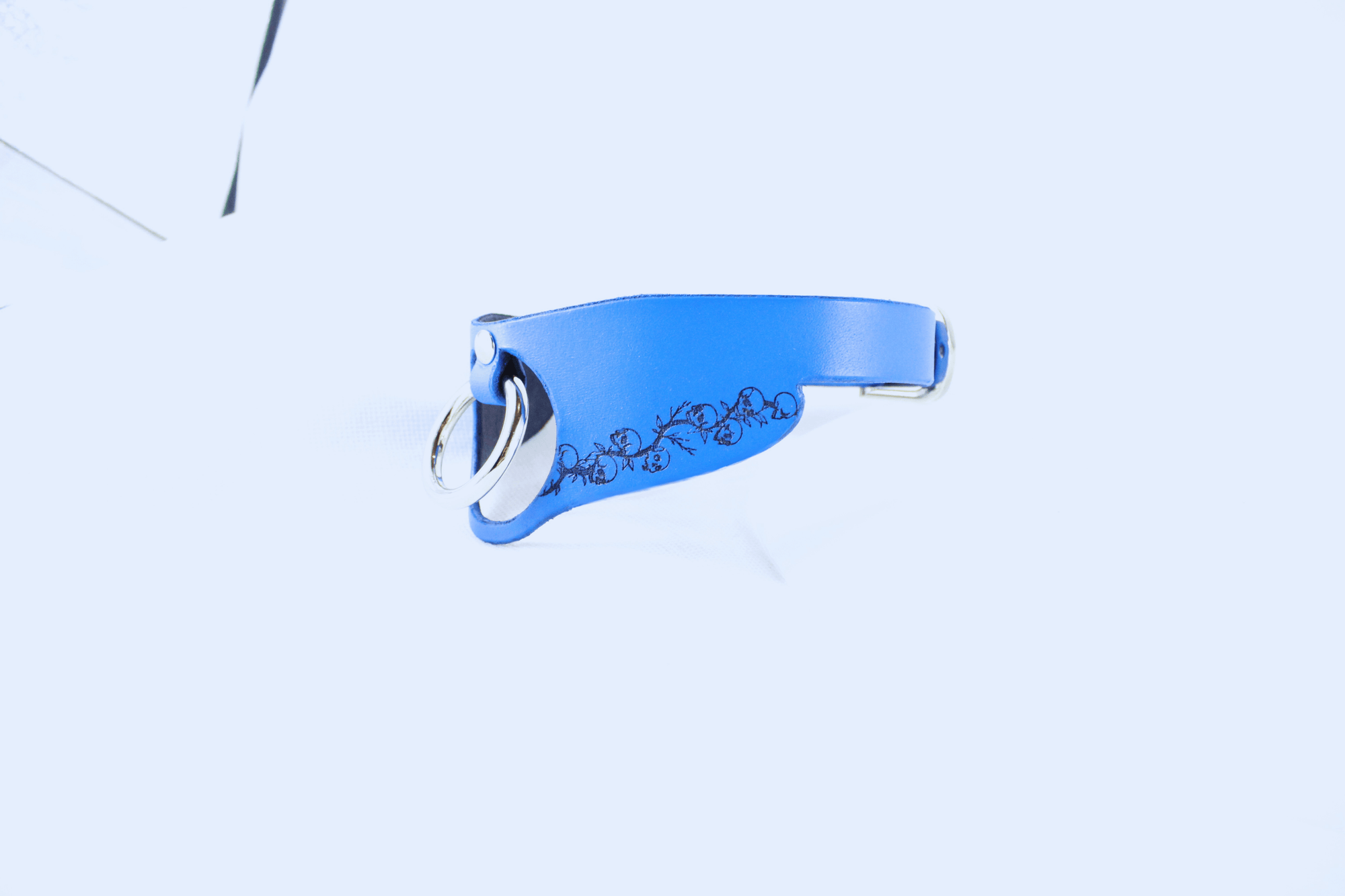 Submissive Collar with Floral Pattern in blue leather, featuring a delicate black floral design and keyring attachment.