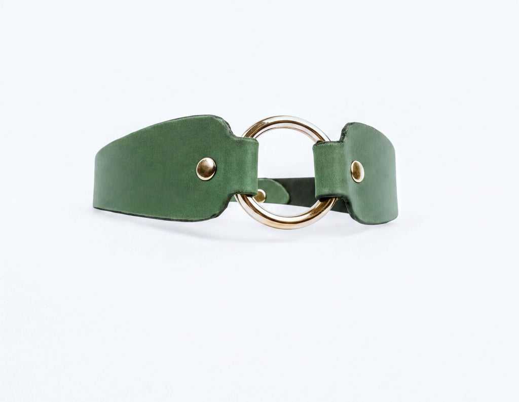 A green leather choker necklace with a gold-colored circular buckle.