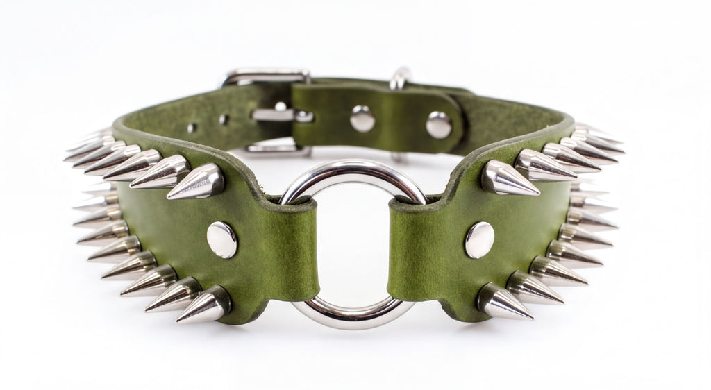 A green leather collar with spikes protruding from it, featuring a metal ring and buckle.